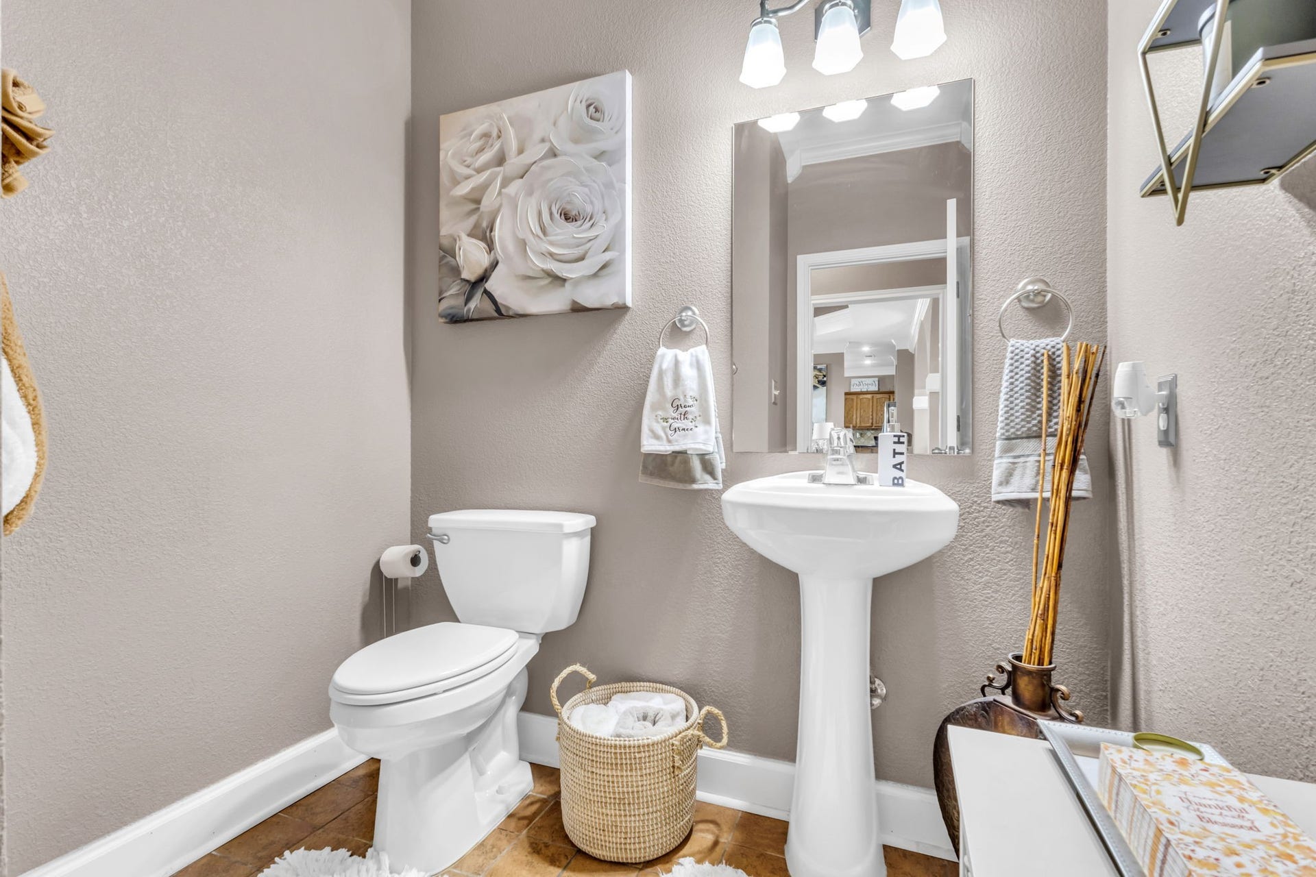 11010 Madison Court, Beaumont, TX 77705 Convenient half bath featuring a pedestal sink, updated light fixture, neutral finishes, and tile flooring. A welcoming space for guests.