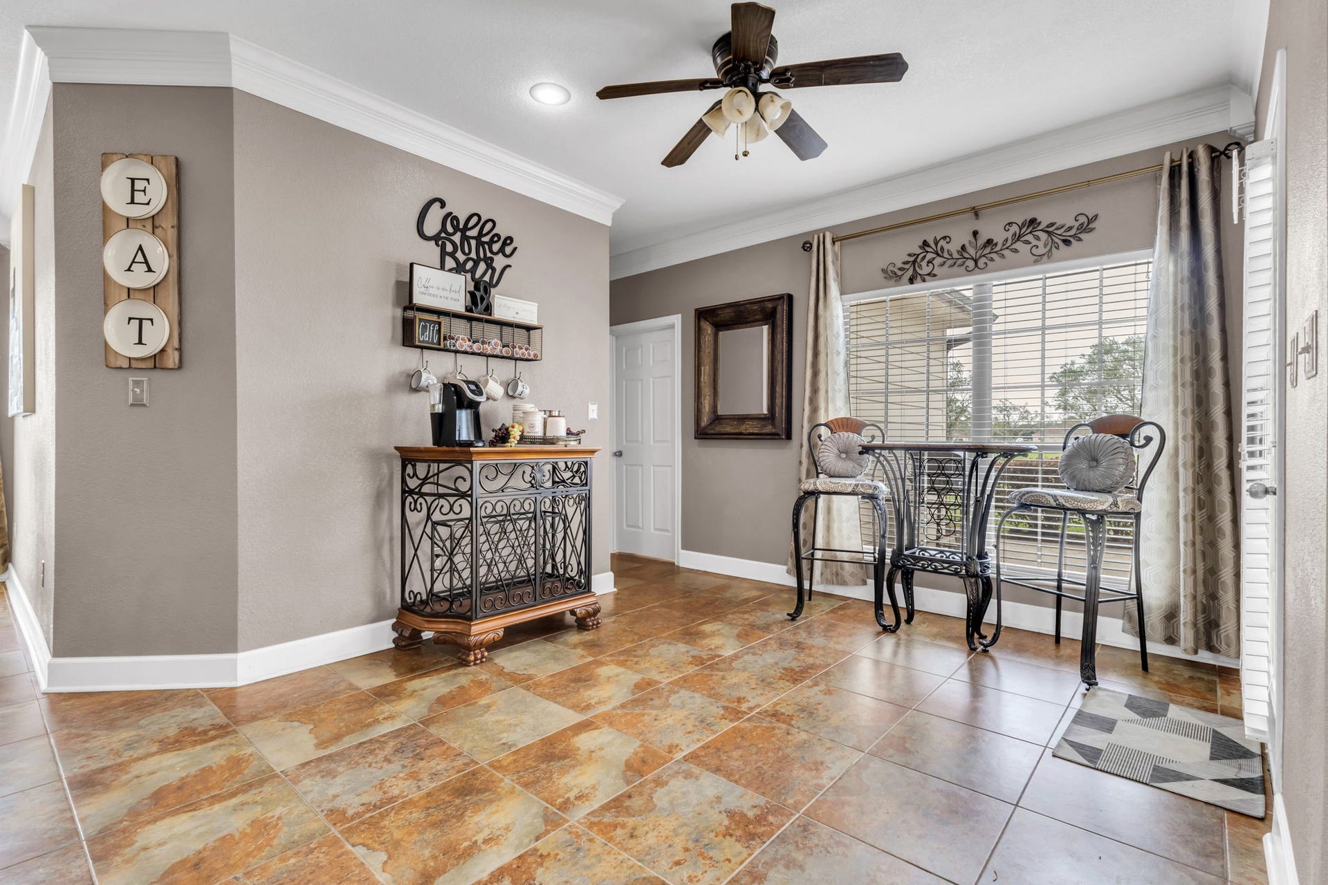11010 Madison Court, Beaumont, TX 77705 Versatile space currently used as a cozy coffee bar and sitting area, featuring a large window, tile flooring, and plenty of natural light. A great spot to enjoy your morning coffee or relax throughout the day.