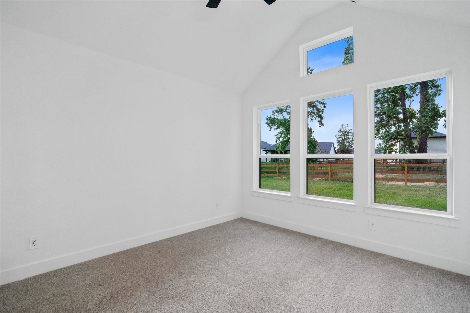 17728 Gold Saddle Lane, Magnolia, TX 77354 Relax and unwind after a long day in this impressive primary suite! This generously sized room offers wood tile flooring, neutral-toned paint, high sloped ceilings with a ceiling fan, and large windows for added comfort and tranquility.