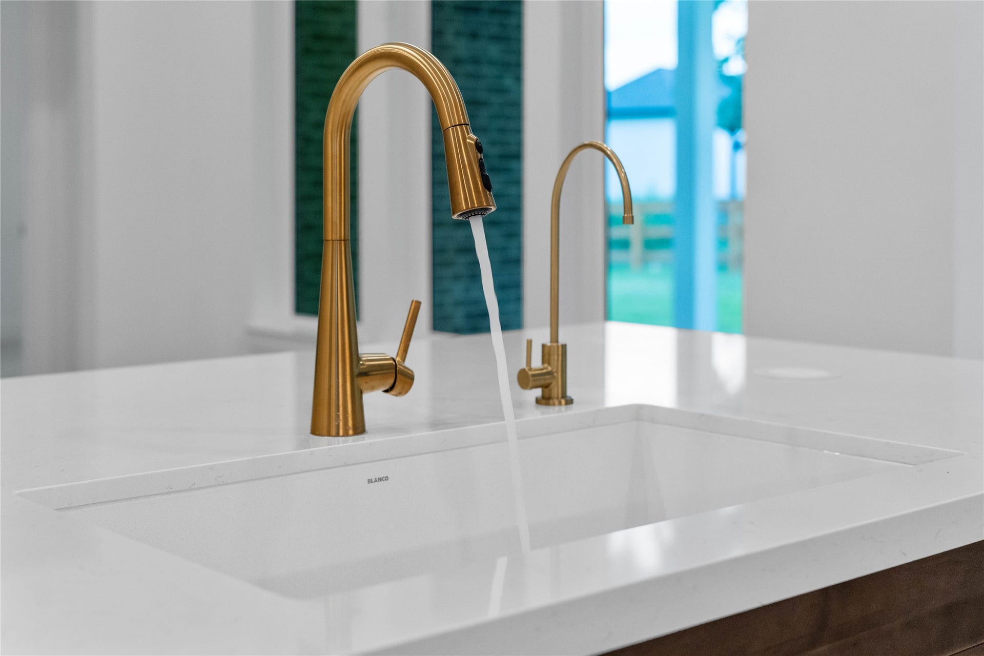 17728 Gold Saddle Lane, Magnolia, TX 77354 A high-end, under-mount single-basin sink is paired with dual champagne bronze fixtures, perfectly blending gourmet utility with a luxury aesthetic.