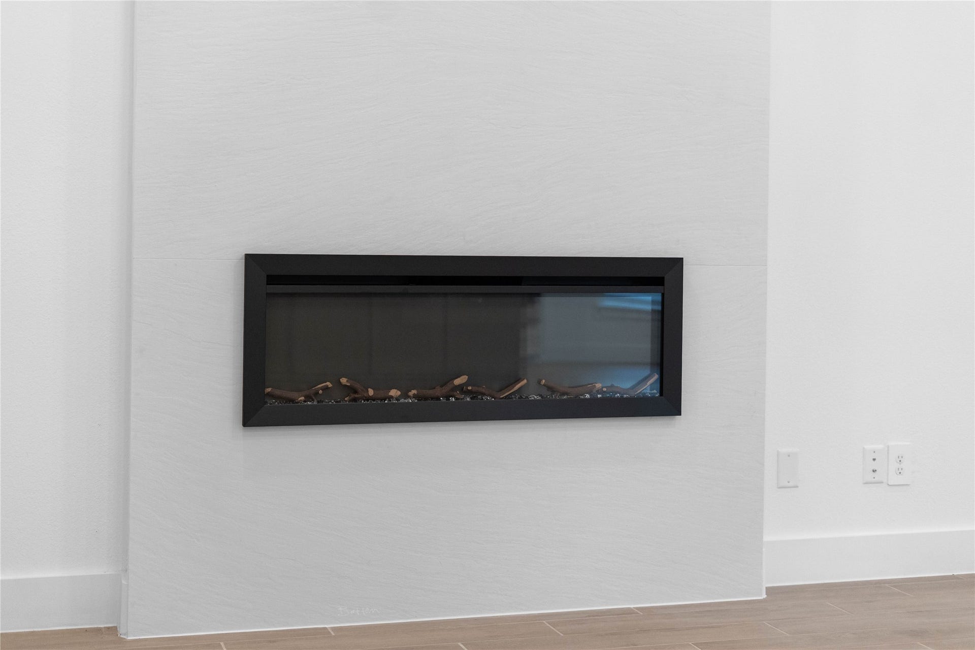 17728 Gold Saddle Lane, Magnolia, TX 77354 A sleek, modern electric fireplace serves as a stunning focal point, blending seamless architectural design with instant cozy ambiance.