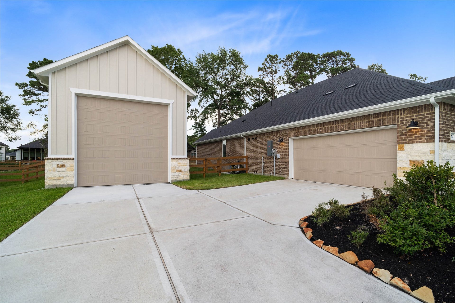17728 Gold Saddle Lane, Magnolia, TX 77354 An expansive concrete driveway connects a detached, high-clearance RV garage with an attached two-car garage, providing a massive parking footprint with plenty of space for multiple vehicles, watercraft, and toys.
