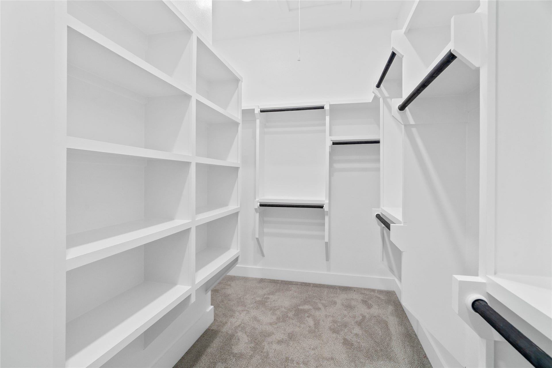 17728 Gold Saddle Lane, Magnolia, TX 77354 An expansive walk-in primary closet features extensive custom-built storage systems designed to maximize organization and wardrobe storage.