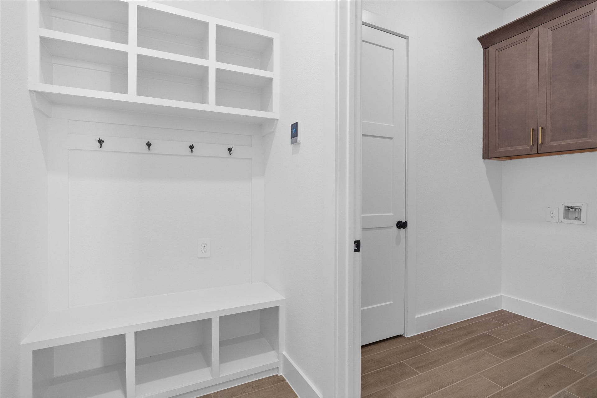 17728 Gold Saddle Lane, Magnolia, TX 77354 A custom-built mudroom drop zone stands adjacent to a spacious laundry room, offering the ultimate combination of home organization and everyday functionality.