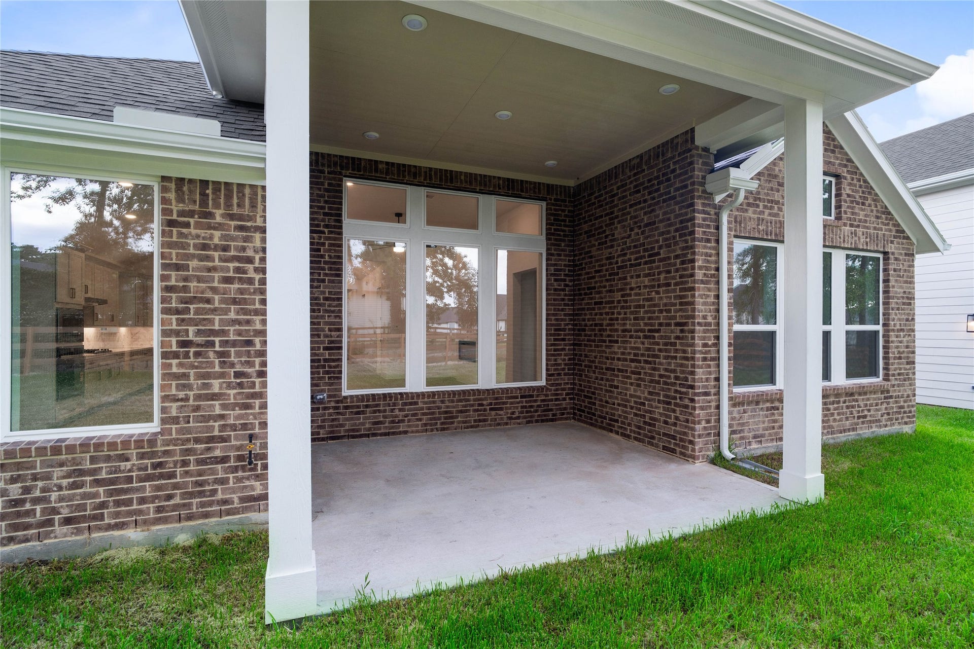 17728 Gold Saddle Lane, Magnolia, TX 77354 A deeply recessed covered back patio serves as a sheltered outdoor retreat, providing a seamless transition between the main home and the backyard.