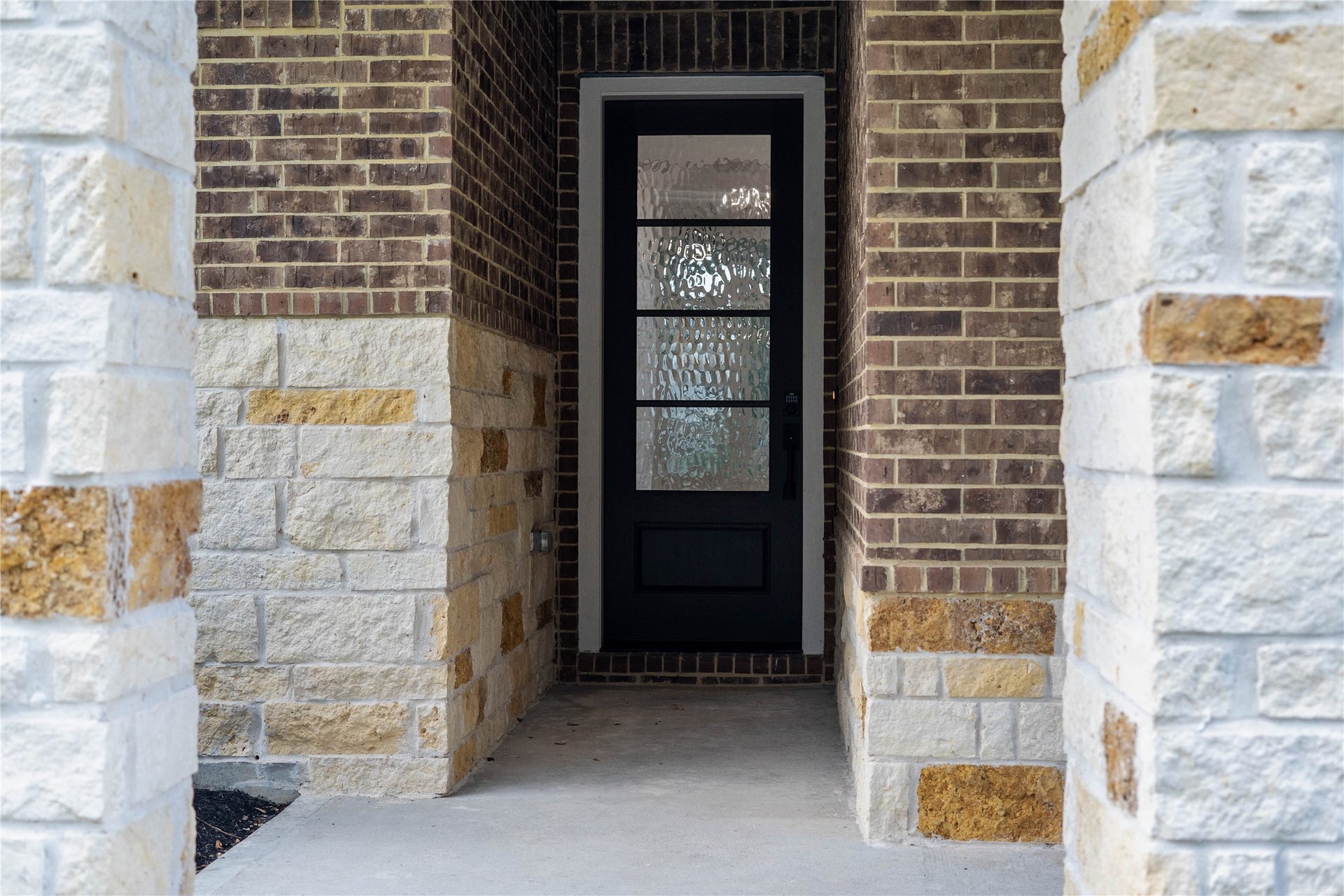 17728 Gold Saddle Lane, Magnolia, TX 77354 This entryway blends traditional masonry textures with modern door design to create a welcoming, upscale facade that delivers instant curb appeal.