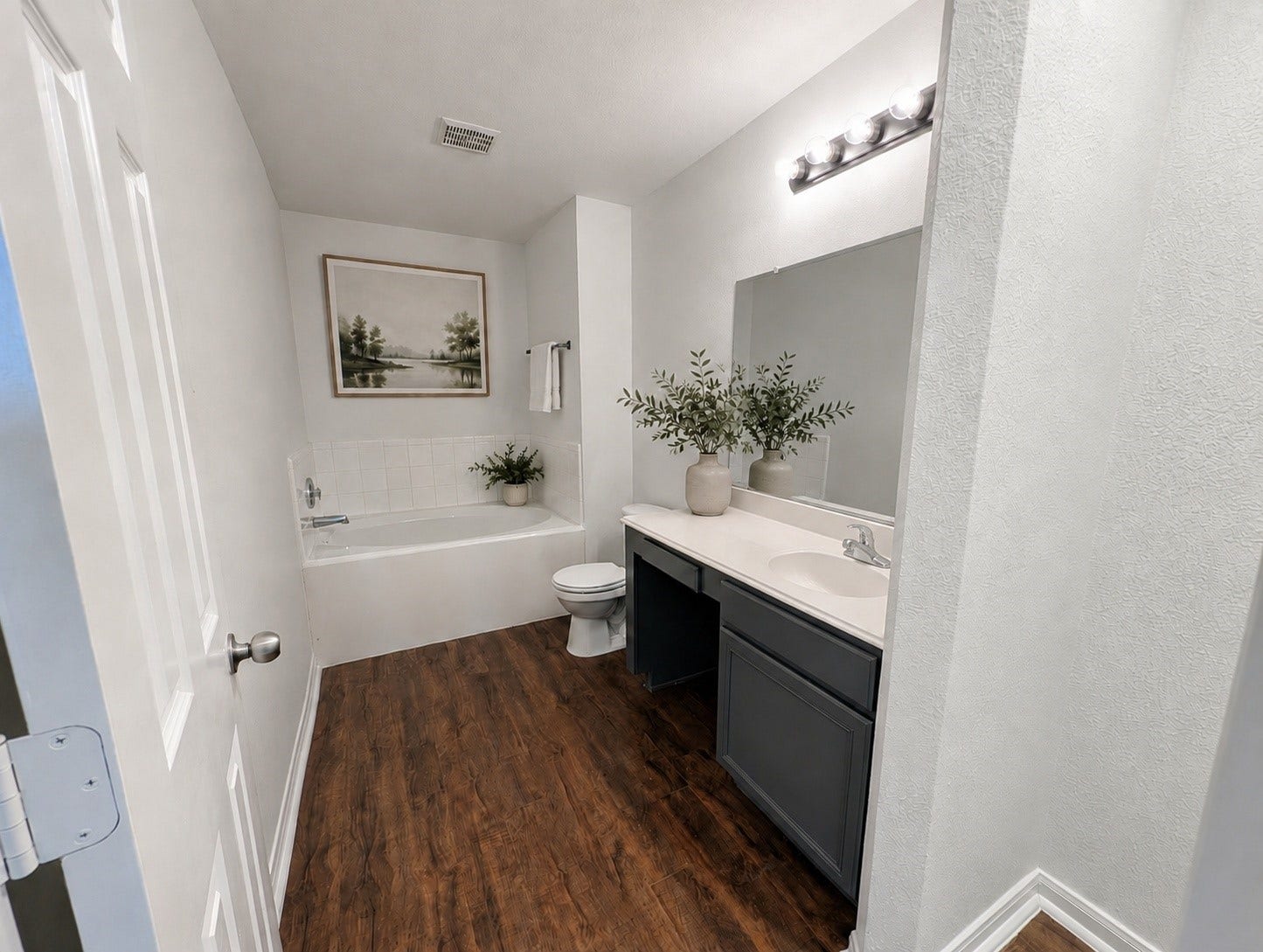2019 Briar Grove Drive, Conroe, TX 77301 A bright and inviting primary bath with generous counter space and a relaxing soaking tub, lightly virtually staged for aesthetic appeal.