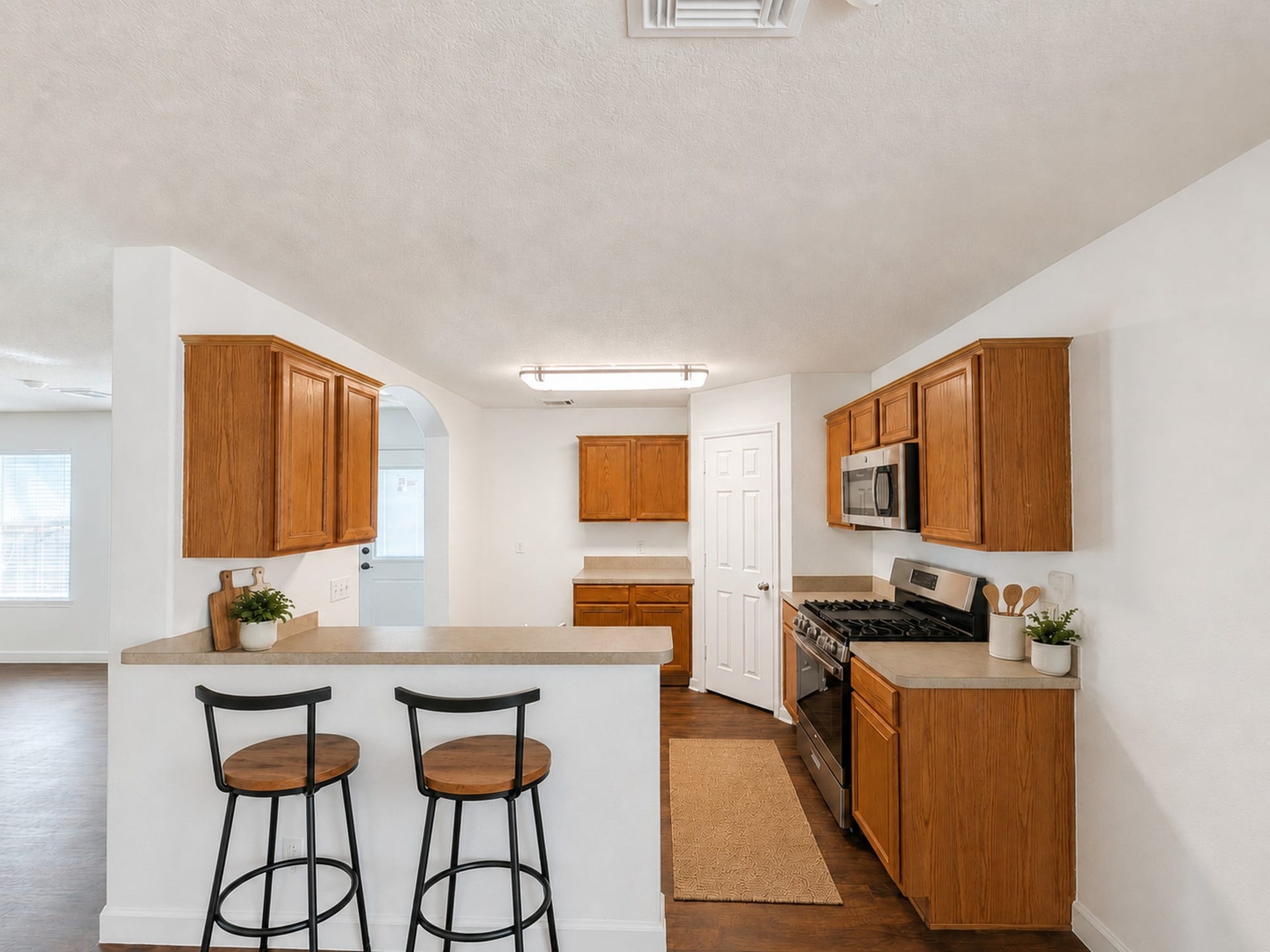 2019 Briar Grove Drive, Conroe, TX 77301 A functional layout ready for your personal touch. This kitchen has been virtually staged to help illustrate its potential. Features include stainless steel appliances, a breakfast bar, pantry, and an open connection to the living area.