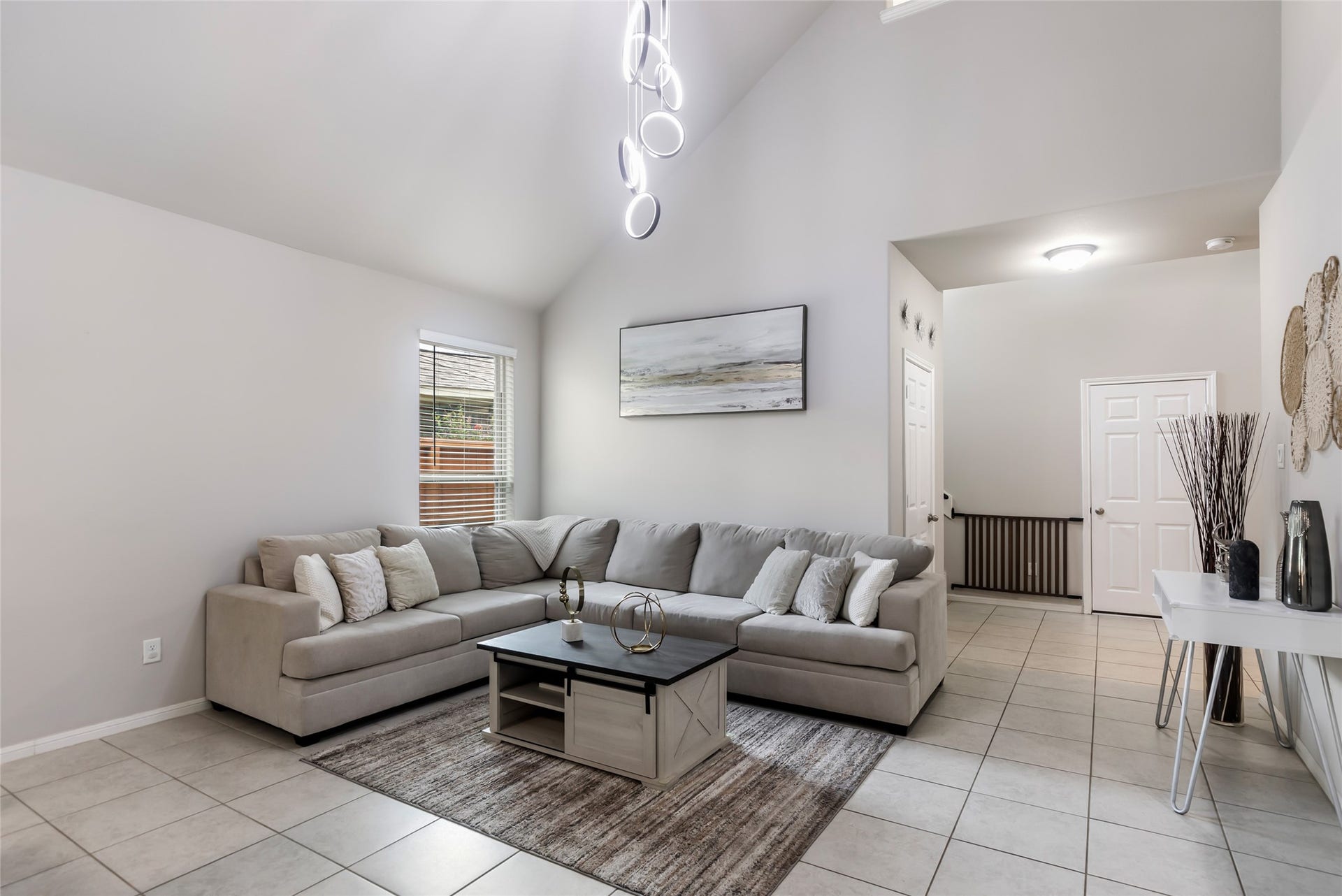 Spacious living room features a bright, open layout and seamless connection to the dining and kitchen areas.