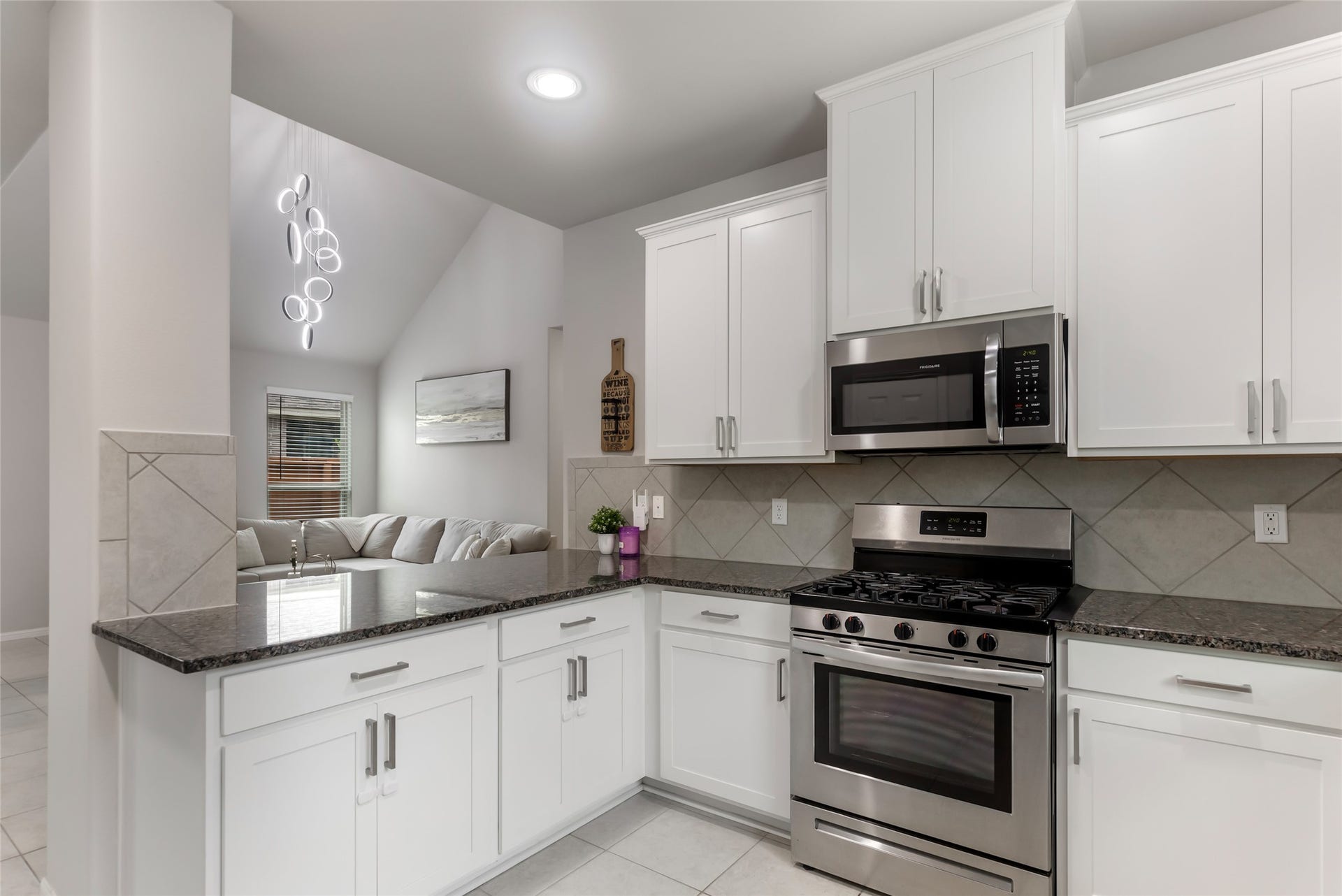 Open kitchen offers plenty of cabinet storage and countertop workspace while remaining connected to the main living areas.