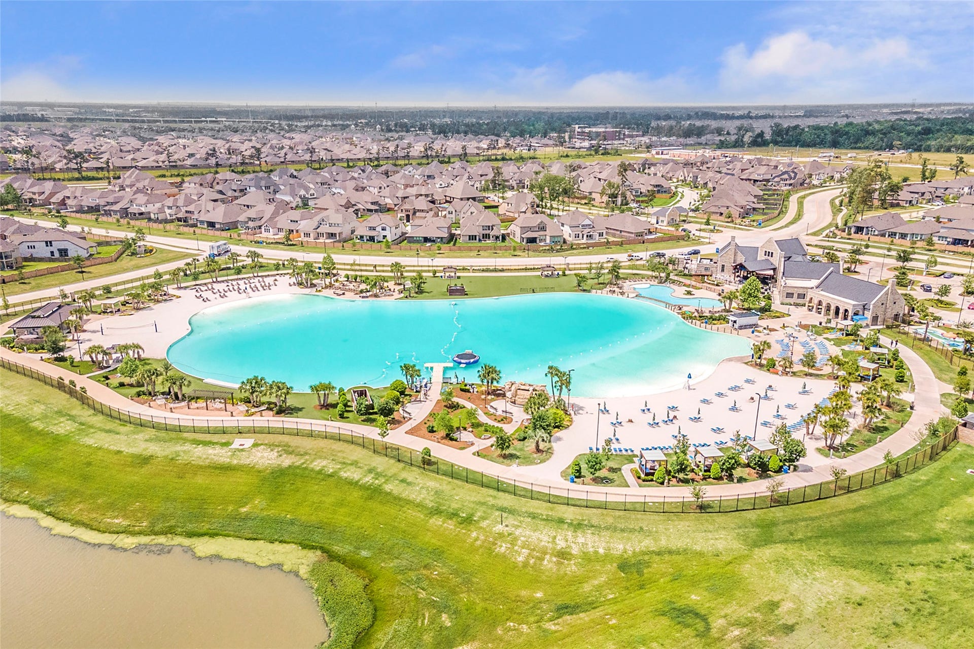 Beautiful aerial view of the lagoon surrounded by sandy beaches, cabanas and inviting outdoor spaces.