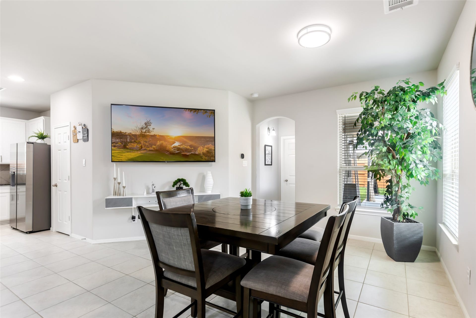 Spacious dining area flows seamlessly into the open-concept living room and kitchen, creating an inviting space for everyday meals and entertaining.