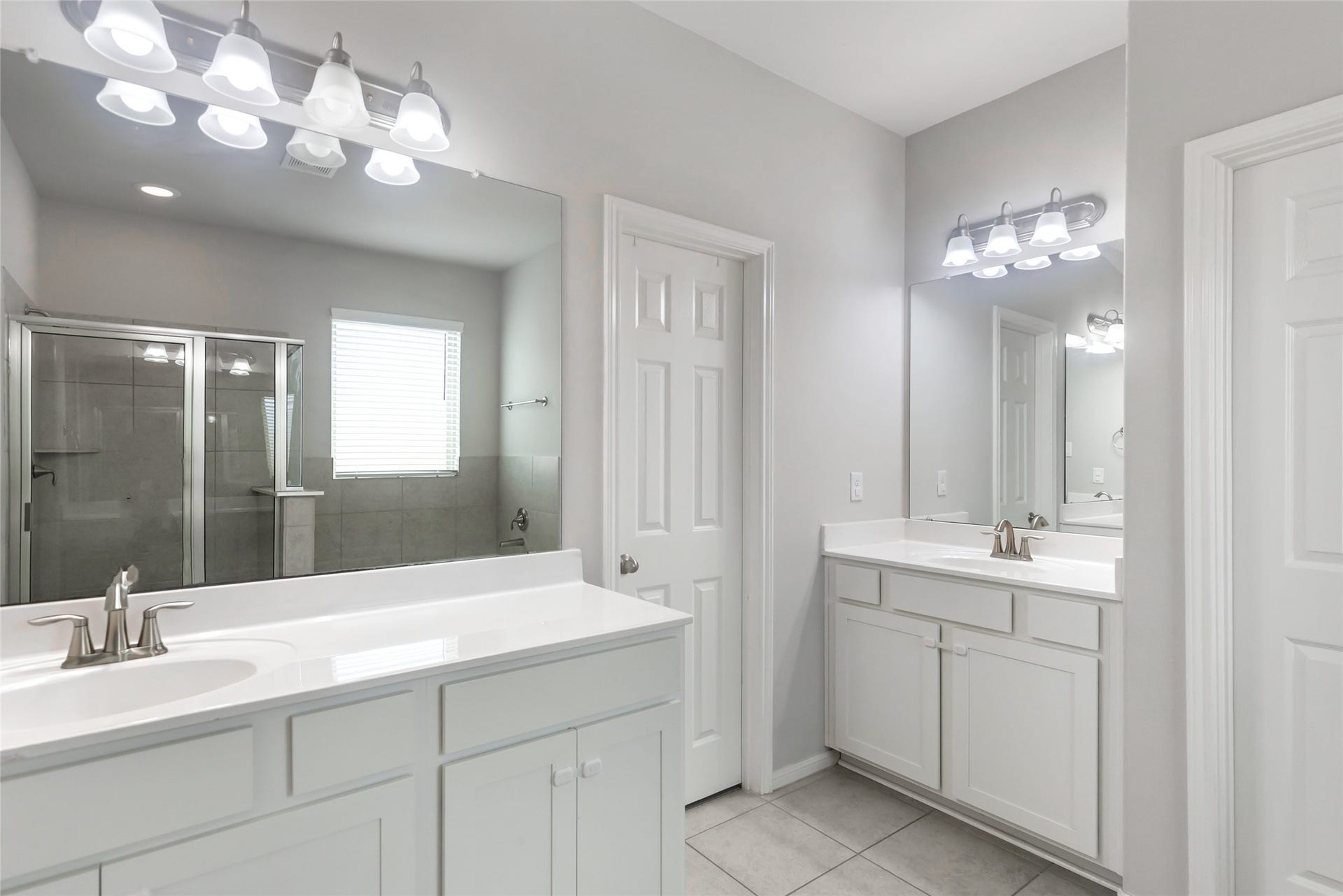 Primary bath features dual vanities, soaking tub, separate shower and ample cabinetry.