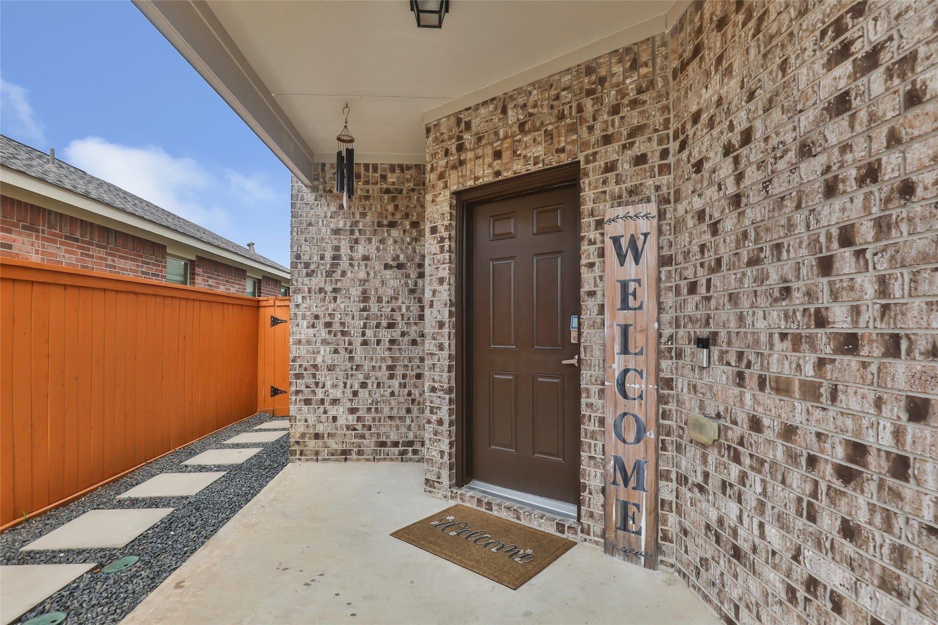 Welcoming covered entry creates a warm first impression with attractive brick detailing and double-door entry.
