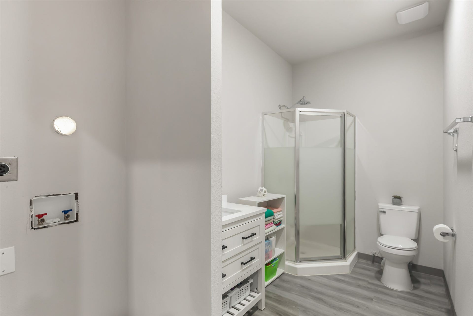Full bathroom serves the converted garage living area and adds even more flexibility. Notice the washer/dryer hooks ups ready for a dedicated (stackable) laundry.