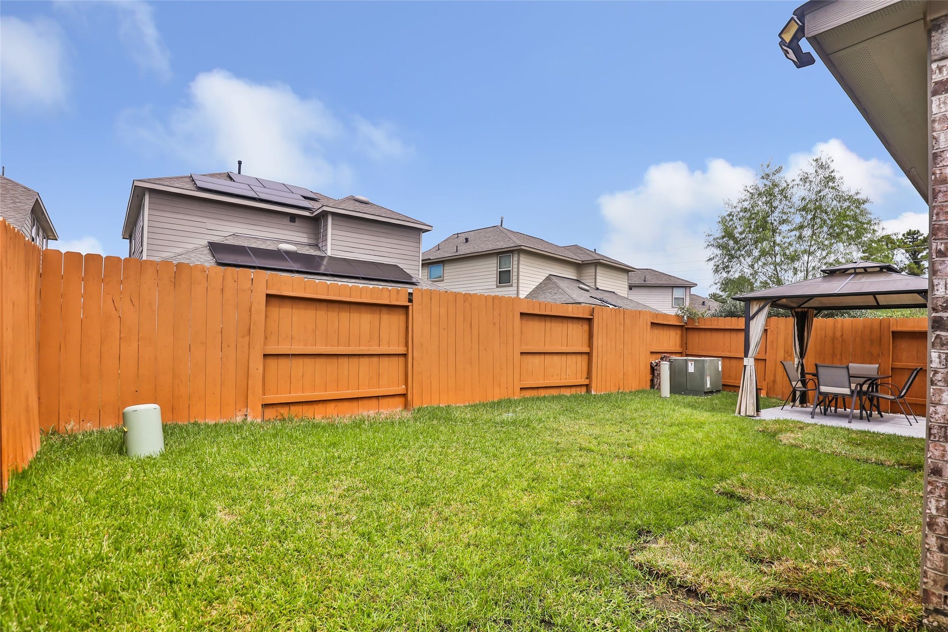 Fenced backyard offers grassy space for pets, play and outdoor enjoyment.