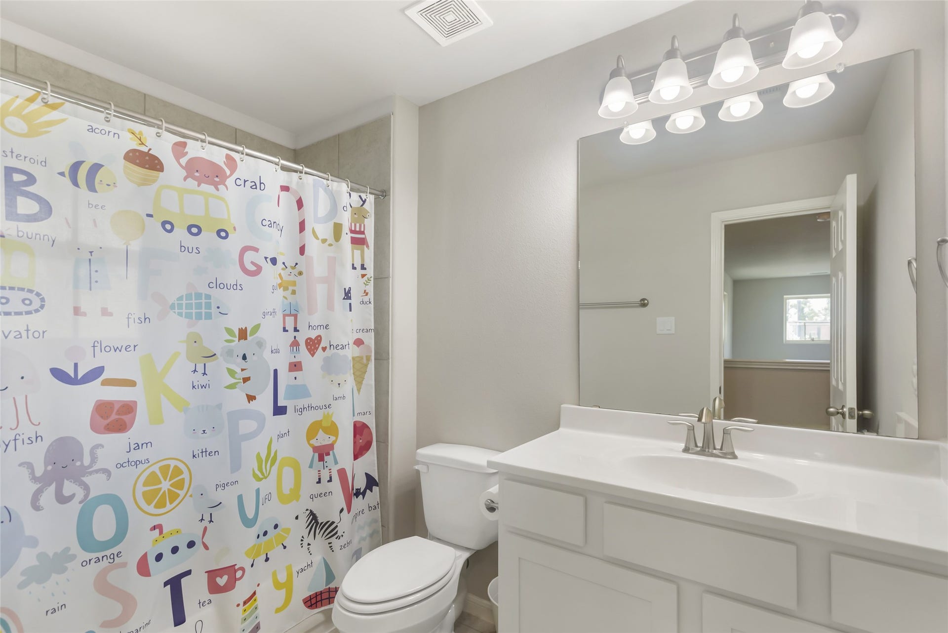 Bright upstairs bathroom features a spacious vanity, modern fixtures and a combination tub/shower for convenient family living.