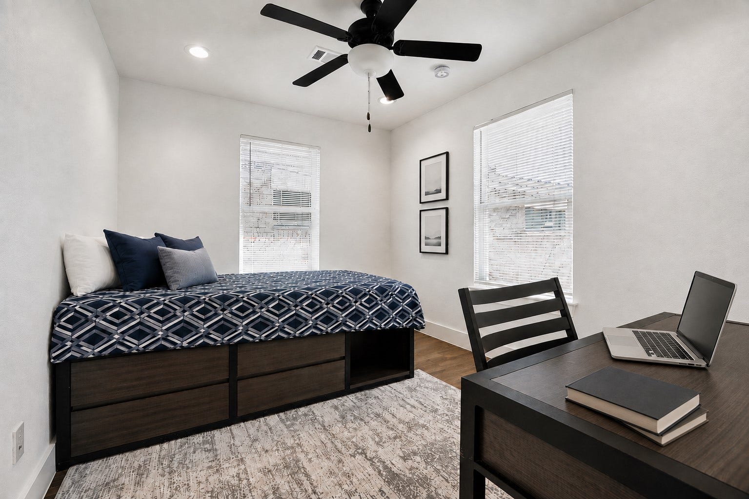 One of the Four Garage unit bedrooms generously sized featuring a functional desk nook.