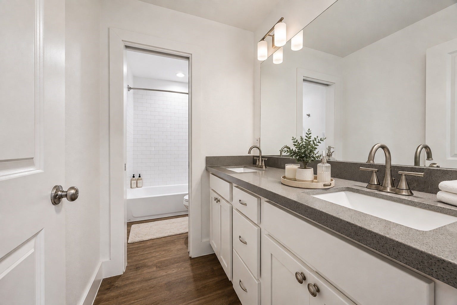 One of the two garage unit bathrooms with double vanities and tub/shower