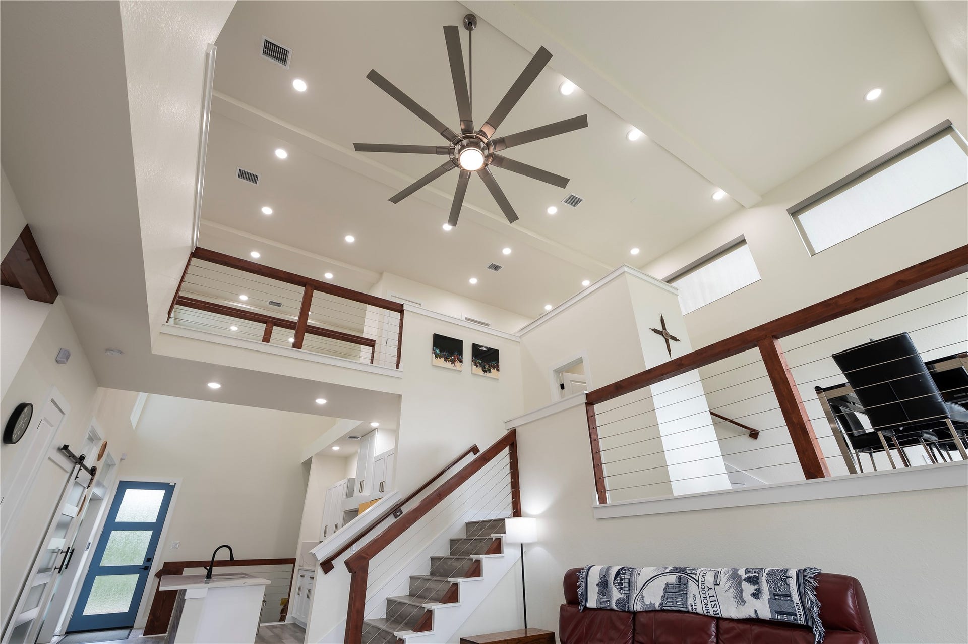 13149 W 6th Street, Santa Fe, TX 77510 Sherwin Williams Swiss Coffee neutral paint tones throughout with 100% LED lighting; upscale ceiling fan and coated horizontal cable stairway and catwalk with cedar railing.