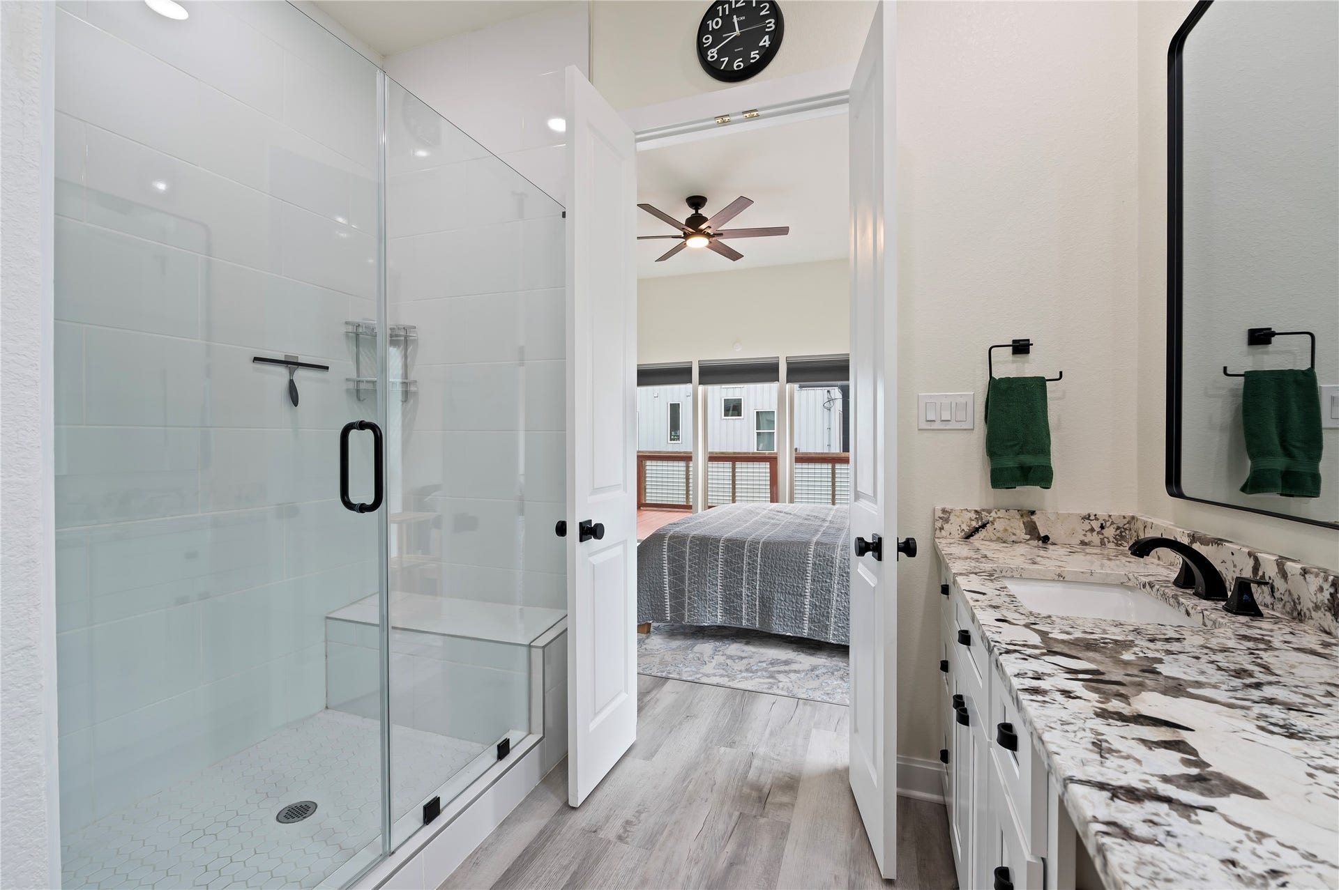13149 W 6th Street, Santa Fe, TX 77510 Oversized walk-in glass shower with seating bench and White Porcelain tile surrounding with honeycomb flooring.