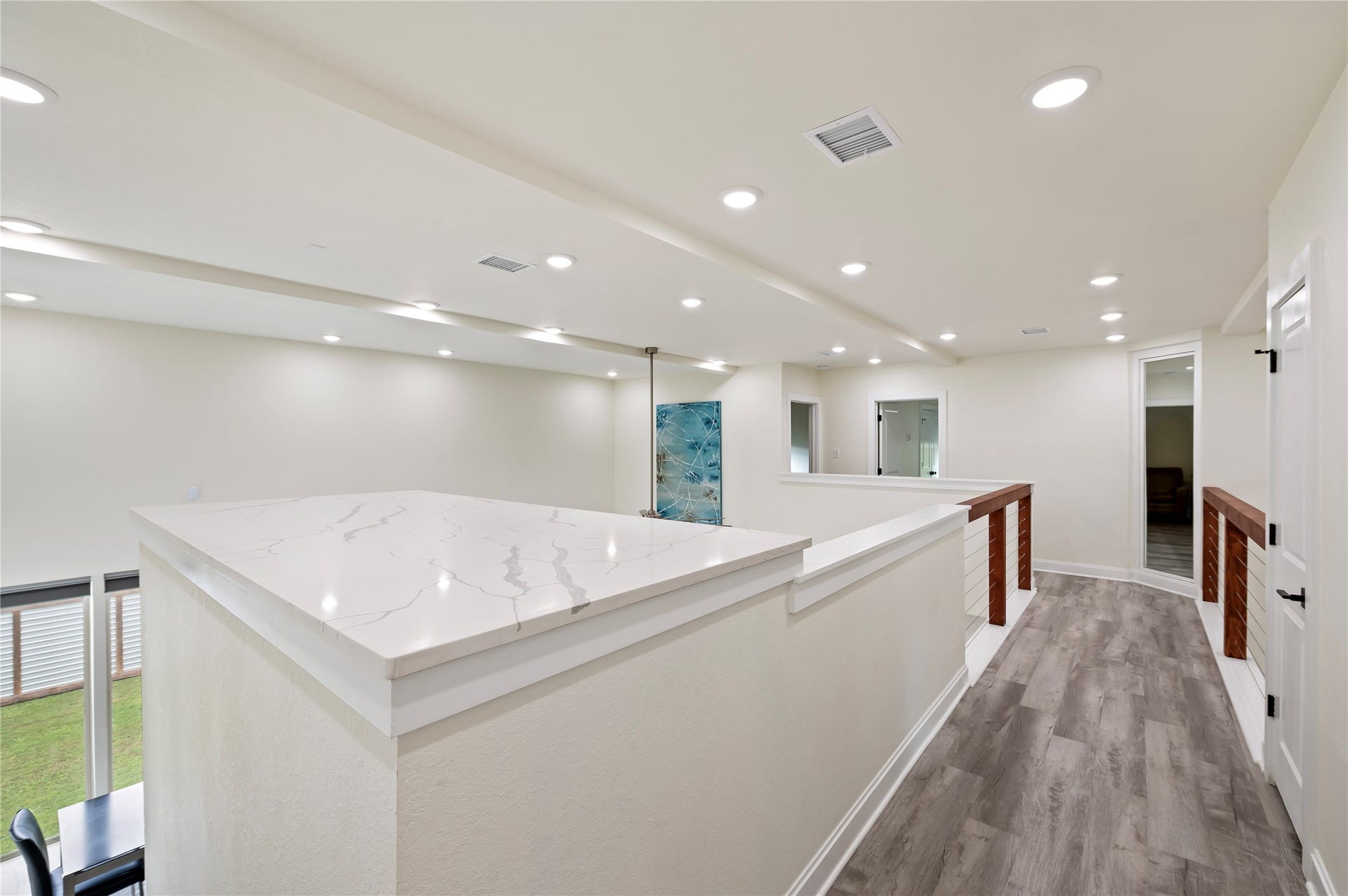 13149 W 6th Street, Santa Fe, TX 77510 Staircase landing with large Quartz countertop art display area. Large insulated mechanical room at the top of the stairs for convenient HVAC access. Coax, Cat-6 and cable available throughout.