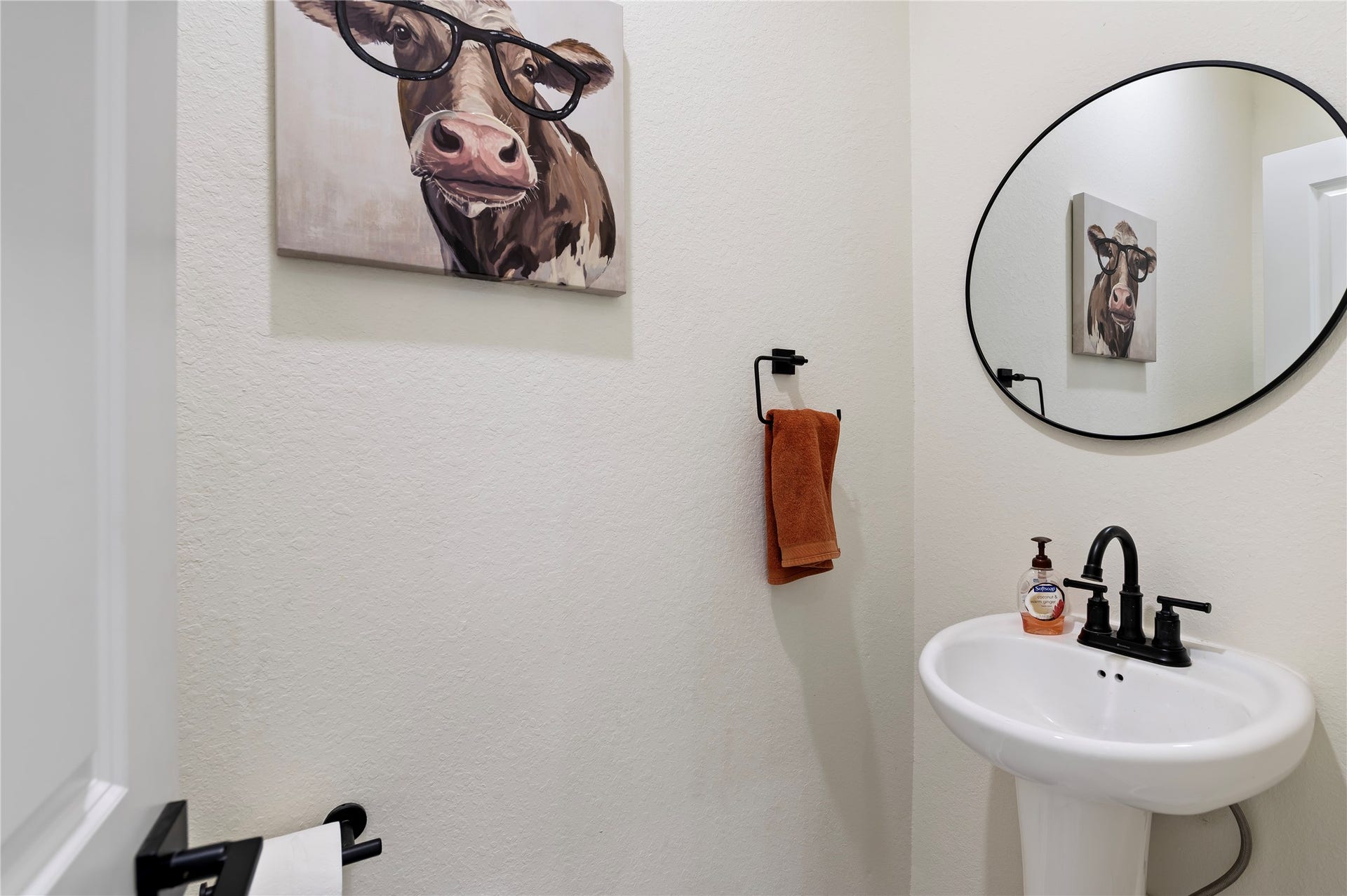 13149 W 6th Street, Santa Fe, TX 77510 Convenient downstairs power room for guests featuring pedestal sink, framed mirror and COREtec Pro Plus Vinyl Plank flooring in Chesapeake Oak.