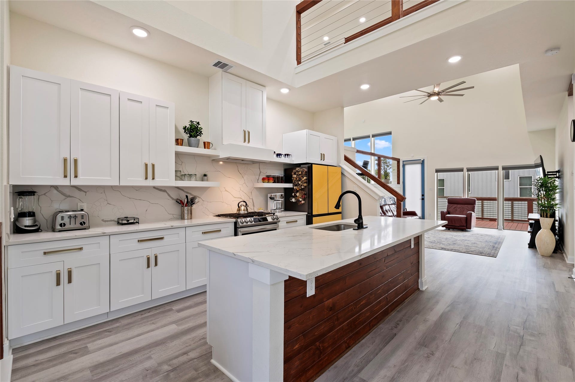 13149 W 6th Street, Santa Fe, TX 77510 Stunning island kitchen with White Quartz countertops and cedar plank accent wall. Updated Samsung Bespoke Dishwasher, Range, and Refrigerator.