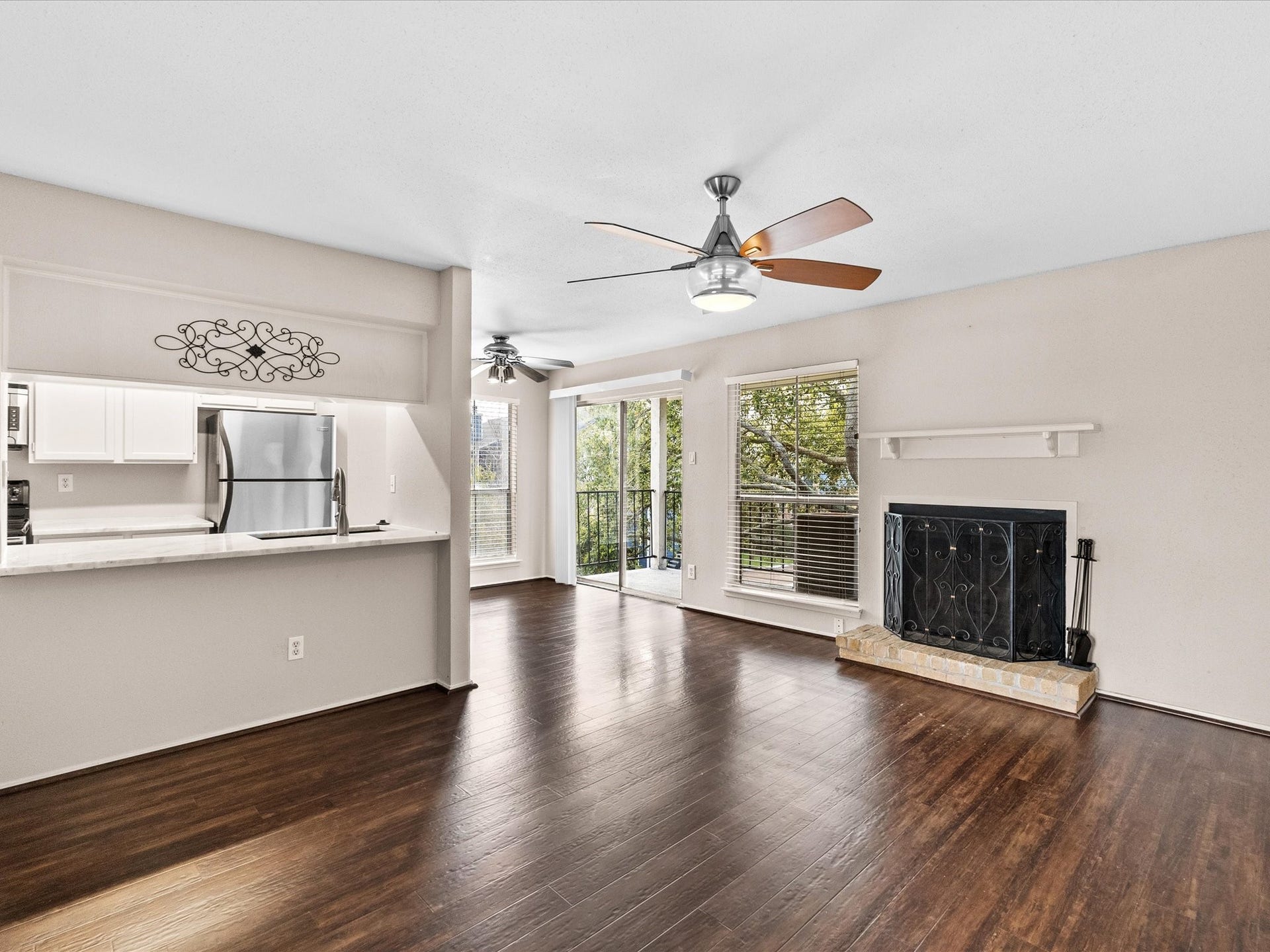 18519 Egret Bay Boulevard, #1802, Webster, TX 77058 Living area features beautiful floors, wood burning fireplace, open to the kitchen and open to one of the two balconies.