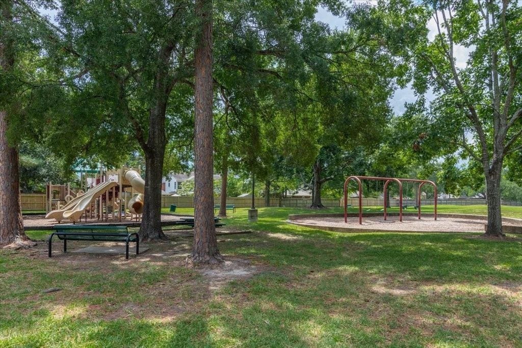 1043 Danforth Drive, Houston, TX 77062 Charming park setting with a playground and swings, surrounded by lush trees and open green space. Perfect for family outings and relaxation.