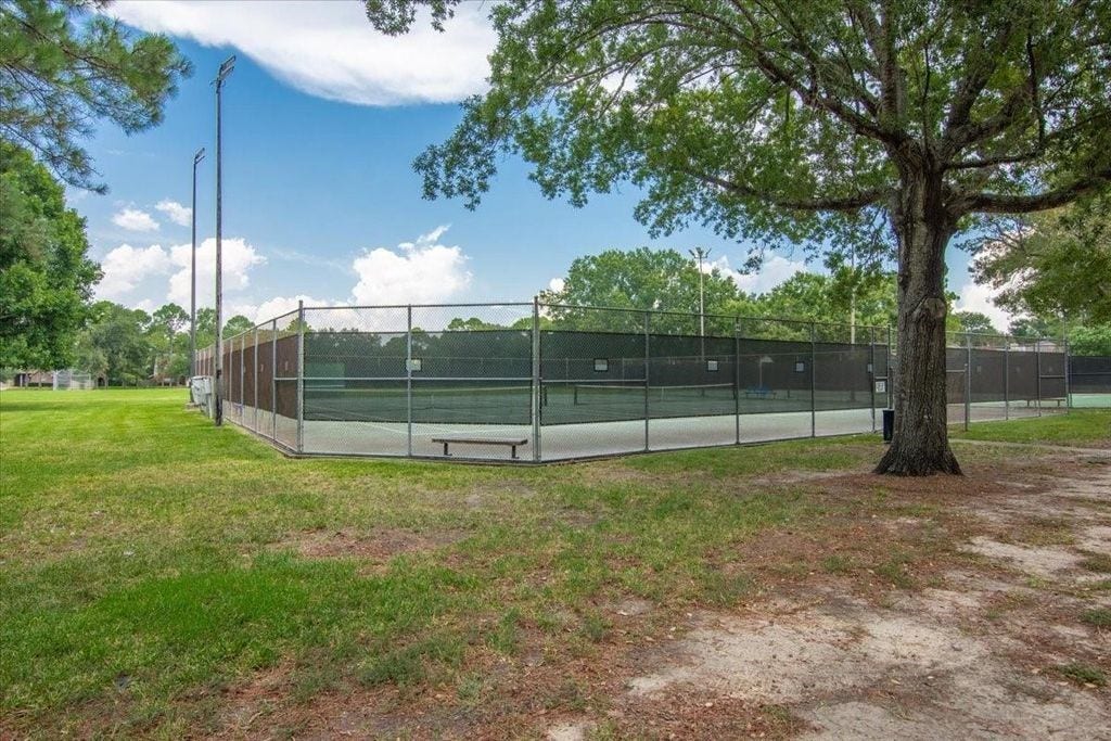 1043 Danforth Drive, Houston, TX 77062 Enjoy outdoor recreation with this well-maintained tennis court set amidst lush greenery, perfect for sports enthusiasts and leisurely play.