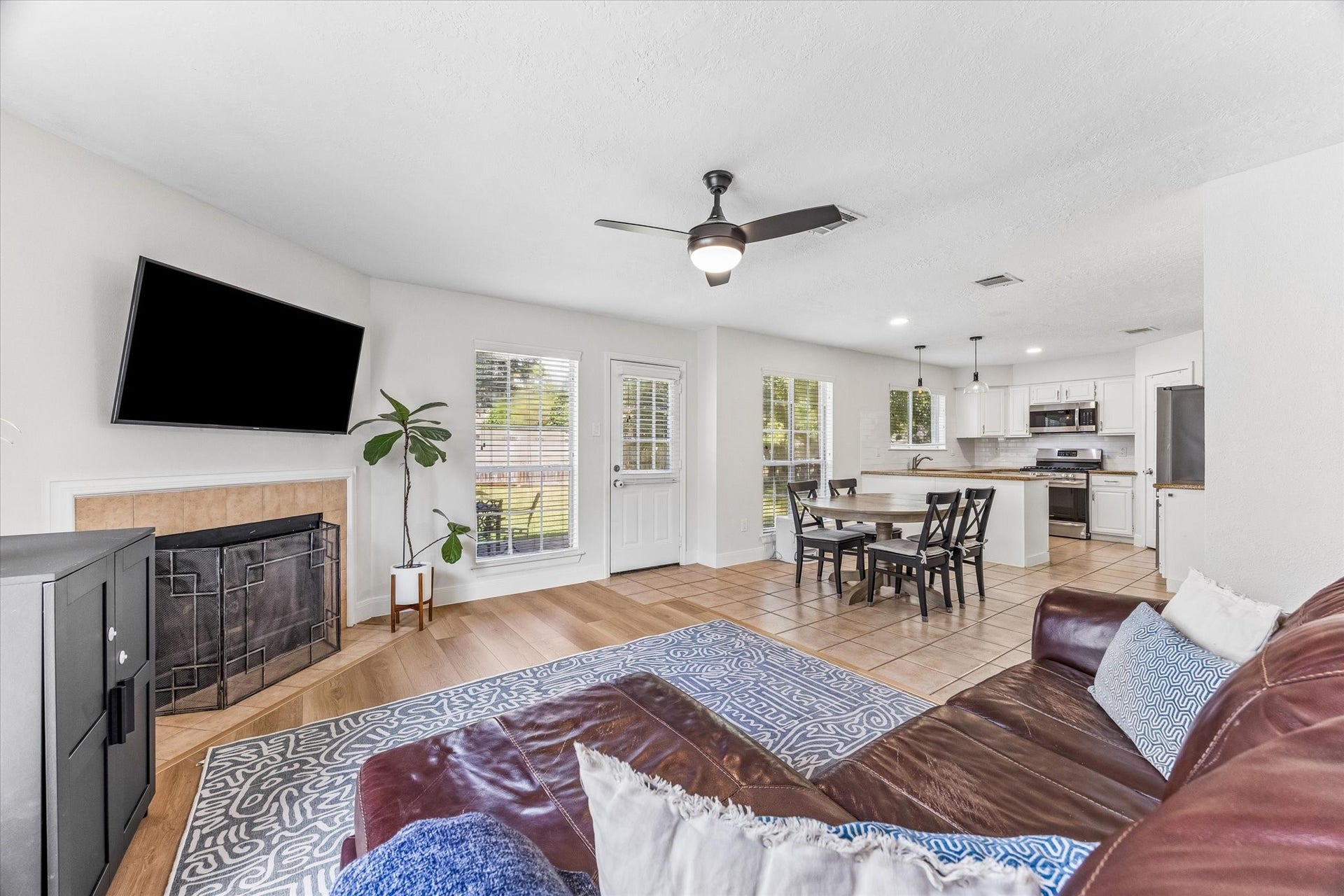 1043 Danforth Drive, Houston, TX 77062 Spacious open-concept living area with a cozy fireplace, modern kitchen, and plenty of natural light, perfect for entertaining.