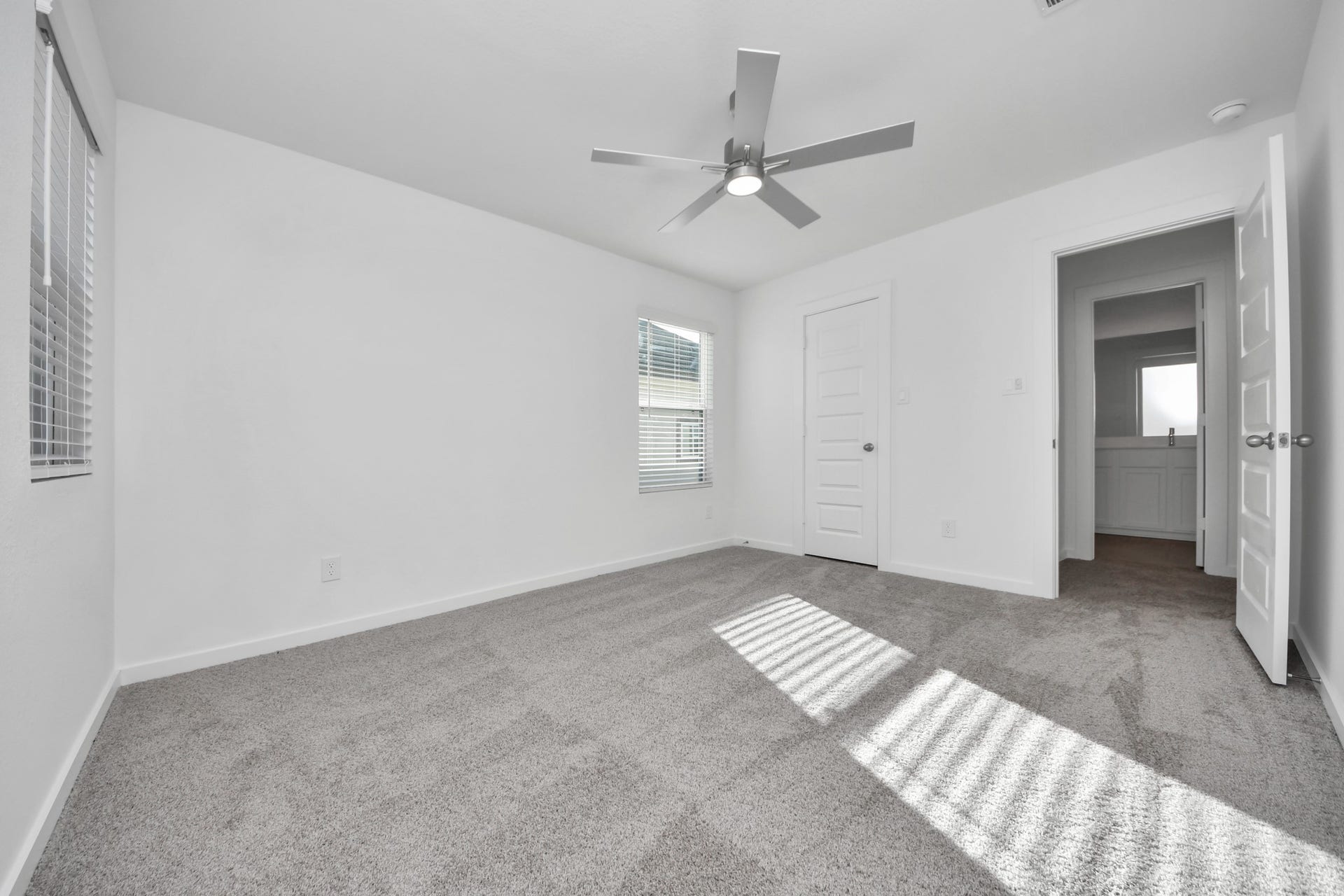 Generously sized secondary bedrooms featuring spacious closets, soft and inviting carpeting underfoot, large windows allowing plenty of natural light, and the added touch of privacy blinds for your personal retreat. Sample photo of completed home with similar floor plan. Actual colors and selections may vary.