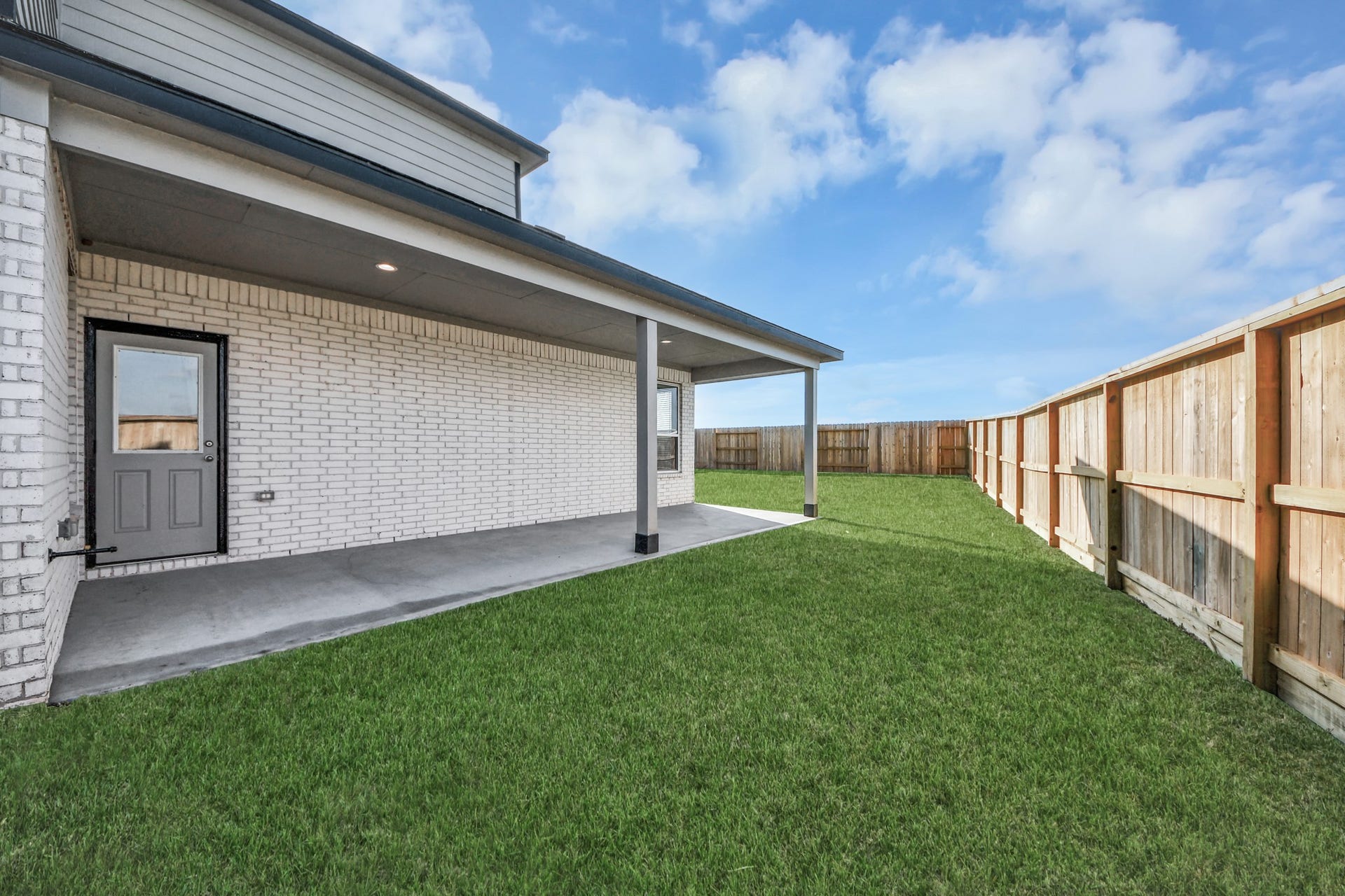 Experience outdoor living at its finest on this expansive covered patio, thoughtfully designed for BBQs and delightful outdoor dining. Sample photo of completed home with similar floor plan. Actual colors and selections may vary.