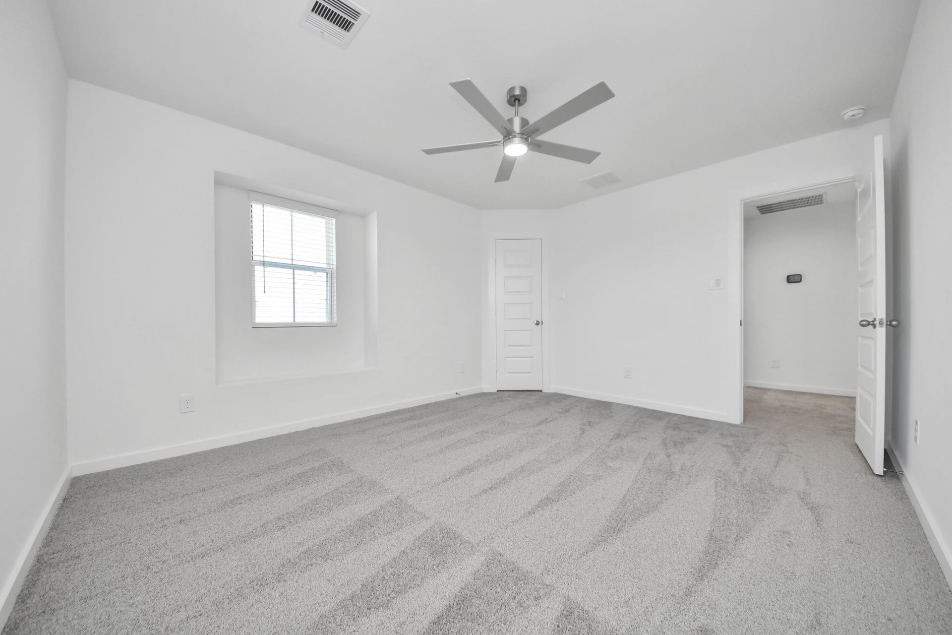 Generously sized secondary bedrooms featuring spacious closets, soft and inviting carpeting underfoot, large windows allowing plenty of natural light, and the added touch of privacy blinds for your personal retreat. Sample photo of completed home with similar floor plan. Actual colors and selections may vary.