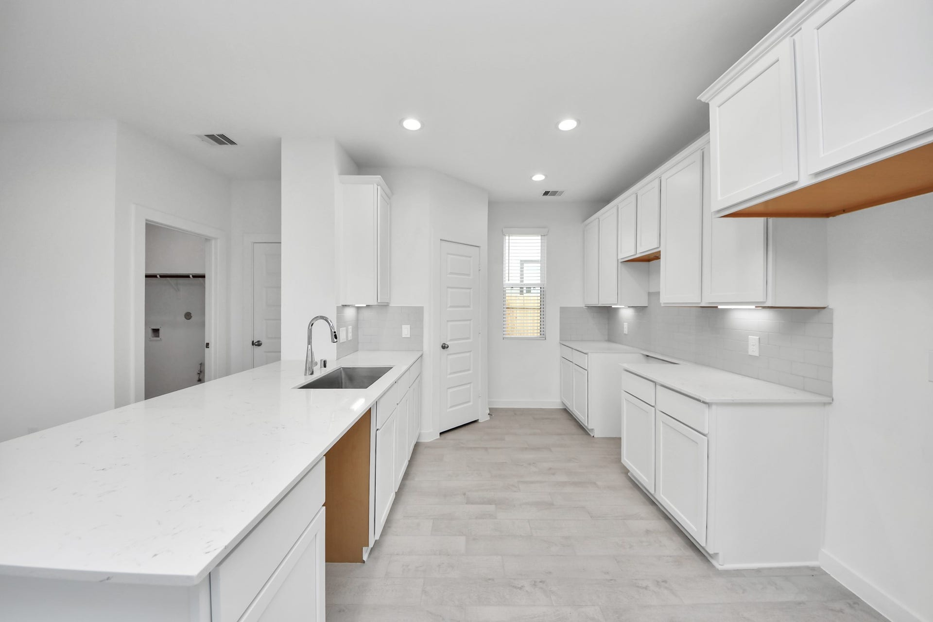 The kitchen is a culinary haven, featuring granite countertops, a tile backsplash, stainless steel appliances, 42 upper cabinets, and undercabinet lighting. Sample photo of completed home with similar floor plan. Actual colors and selections may vary.