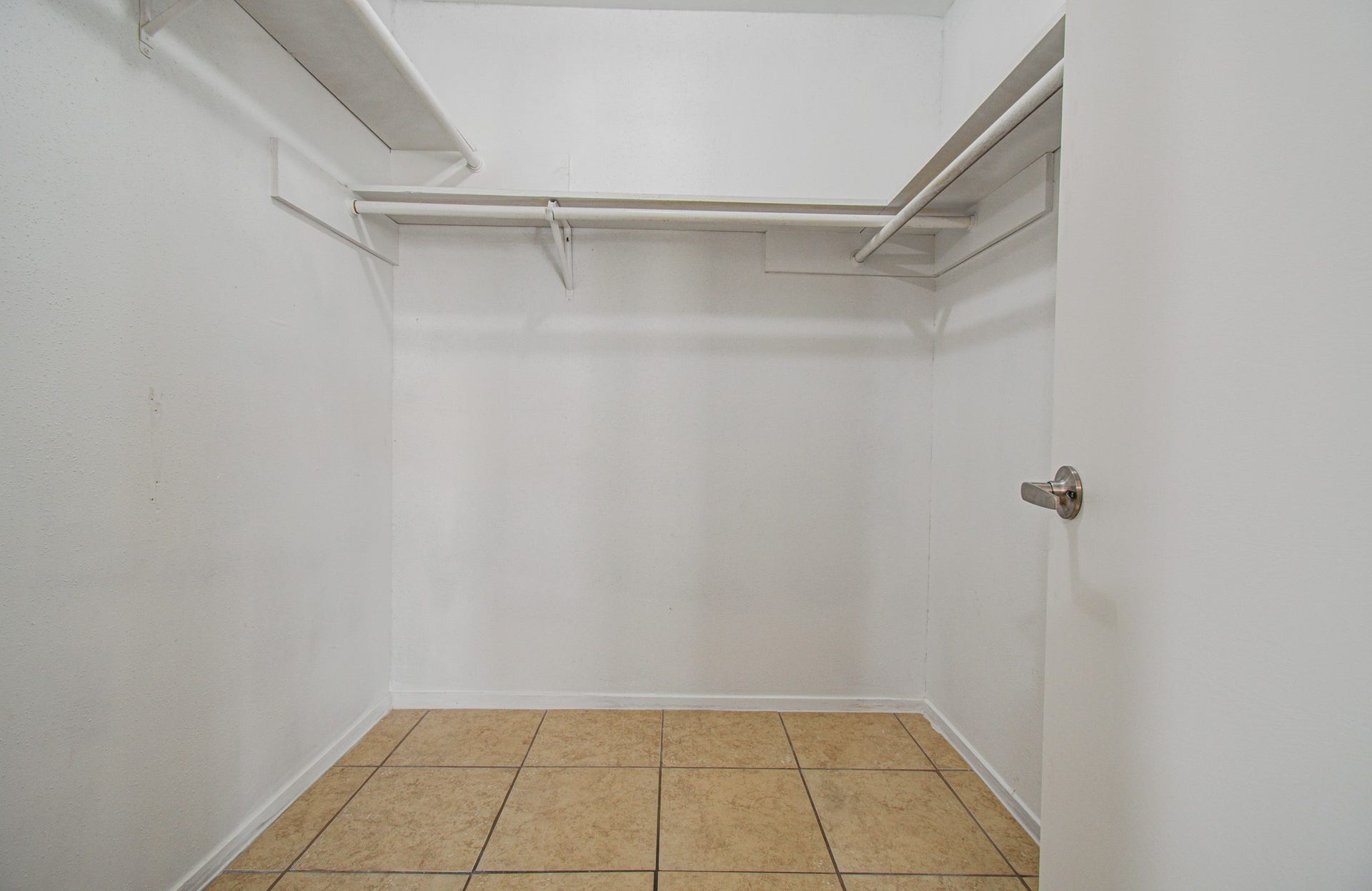 7319 Skybright Lane, Houston, TX 77095 Spacious walk-in closet featuring ample shelving and tiled flooring for organized storage.