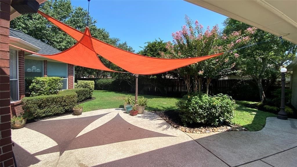 5510 Cherry Creek Bend Court, Houston, TX 77041 Experience serene outdoor relaxation in the shaded backyard oasis.