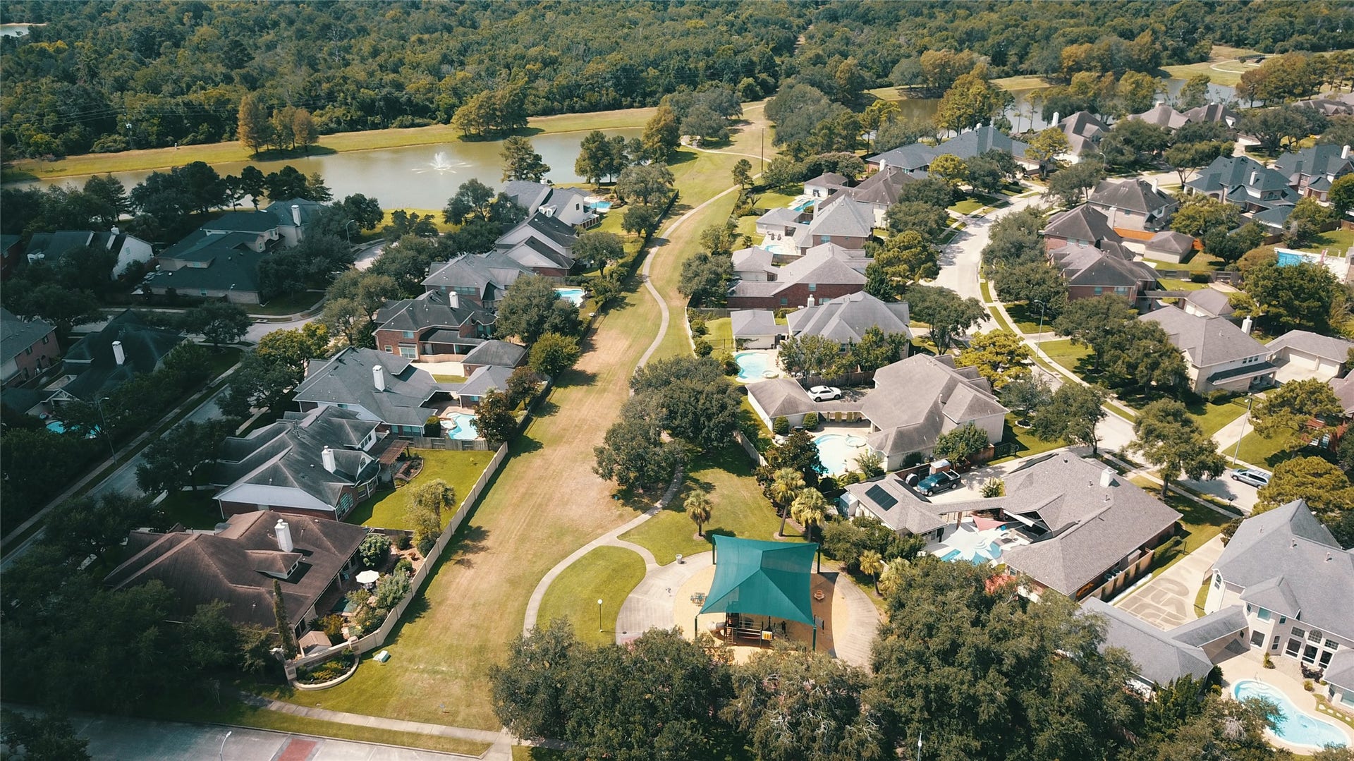 5510 Cherry Creek Bend Court, Houston, TX 77041 A charming playground nestled next to scenic lakes, perfect for family fun and relaxation.