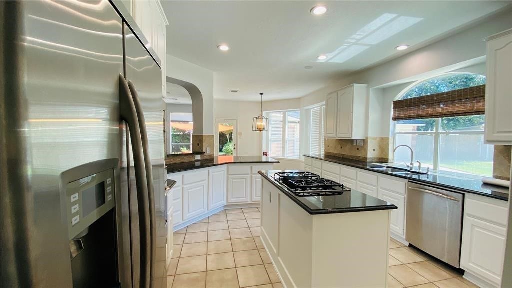 5510 Cherry Creek Bend Court, Houston, TX 77041 Modern island kitchen with sleek countertops, ample cabinetry, and stainless steel appliancesideal for cooking and entertaining.