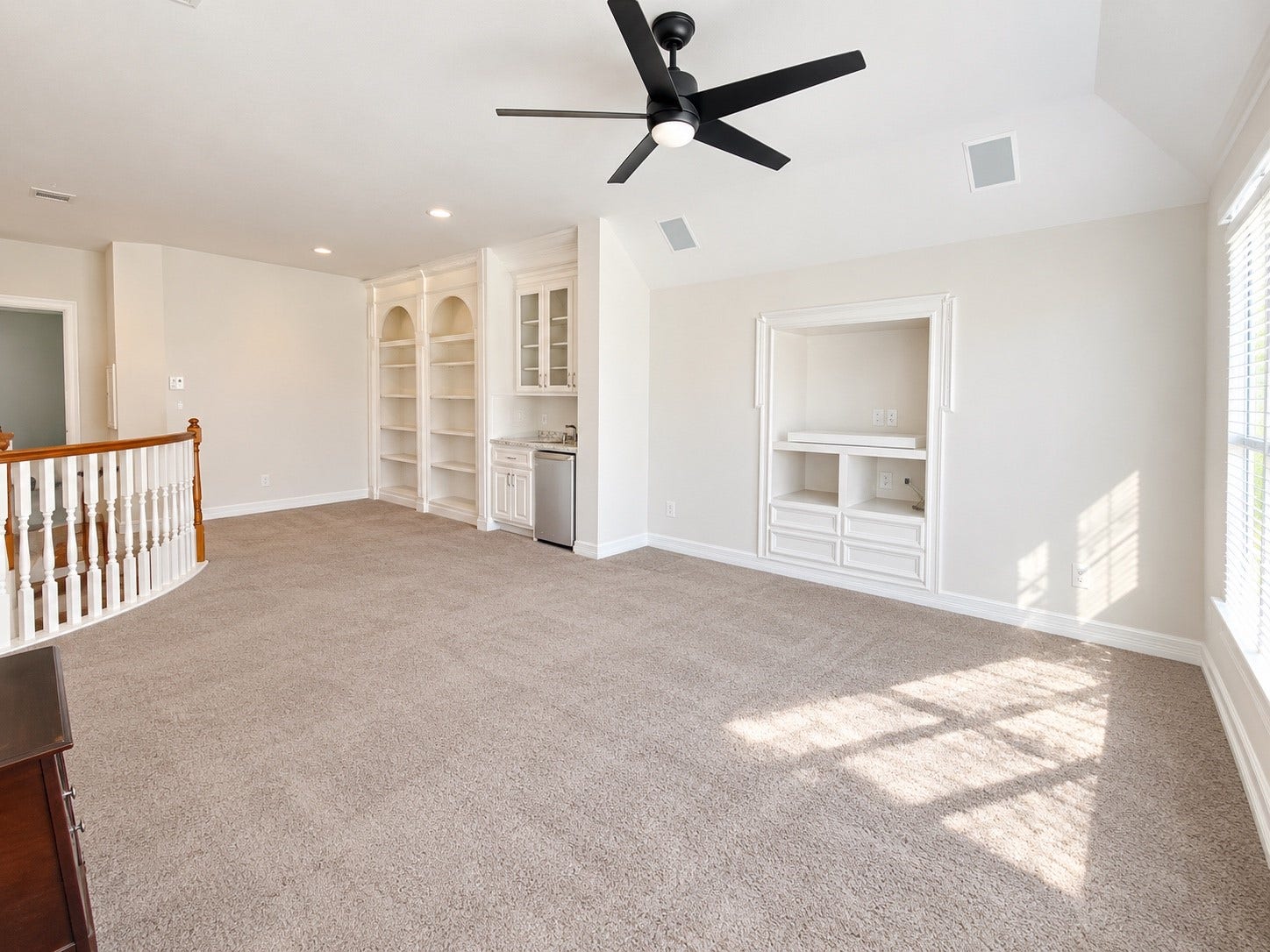 5510 Cherry Creek Bend Court, Houston, TX 77041 Spacious game room featuring built-in shelving, a wet bar, and ample natural lightperfect for entertaining.