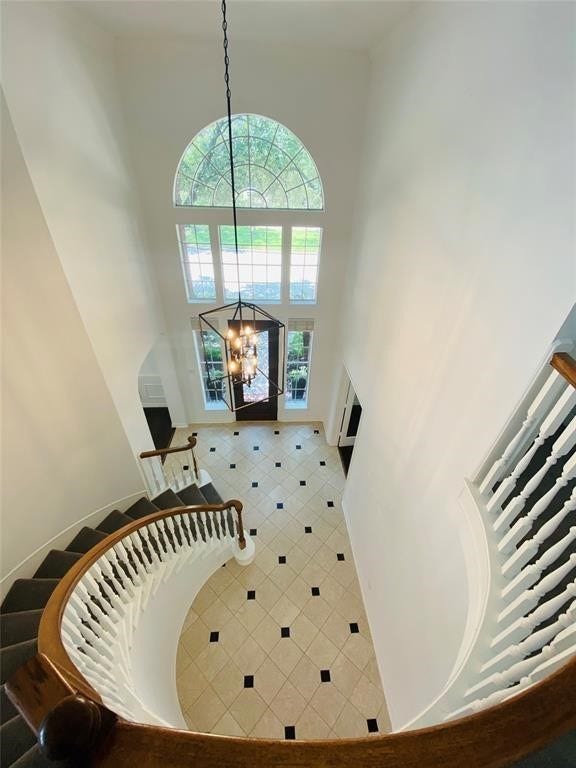 5510 Cherry Creek Bend Court, Houston, TX 77041 Elegant curved staircase enhances the home's grand entrance.