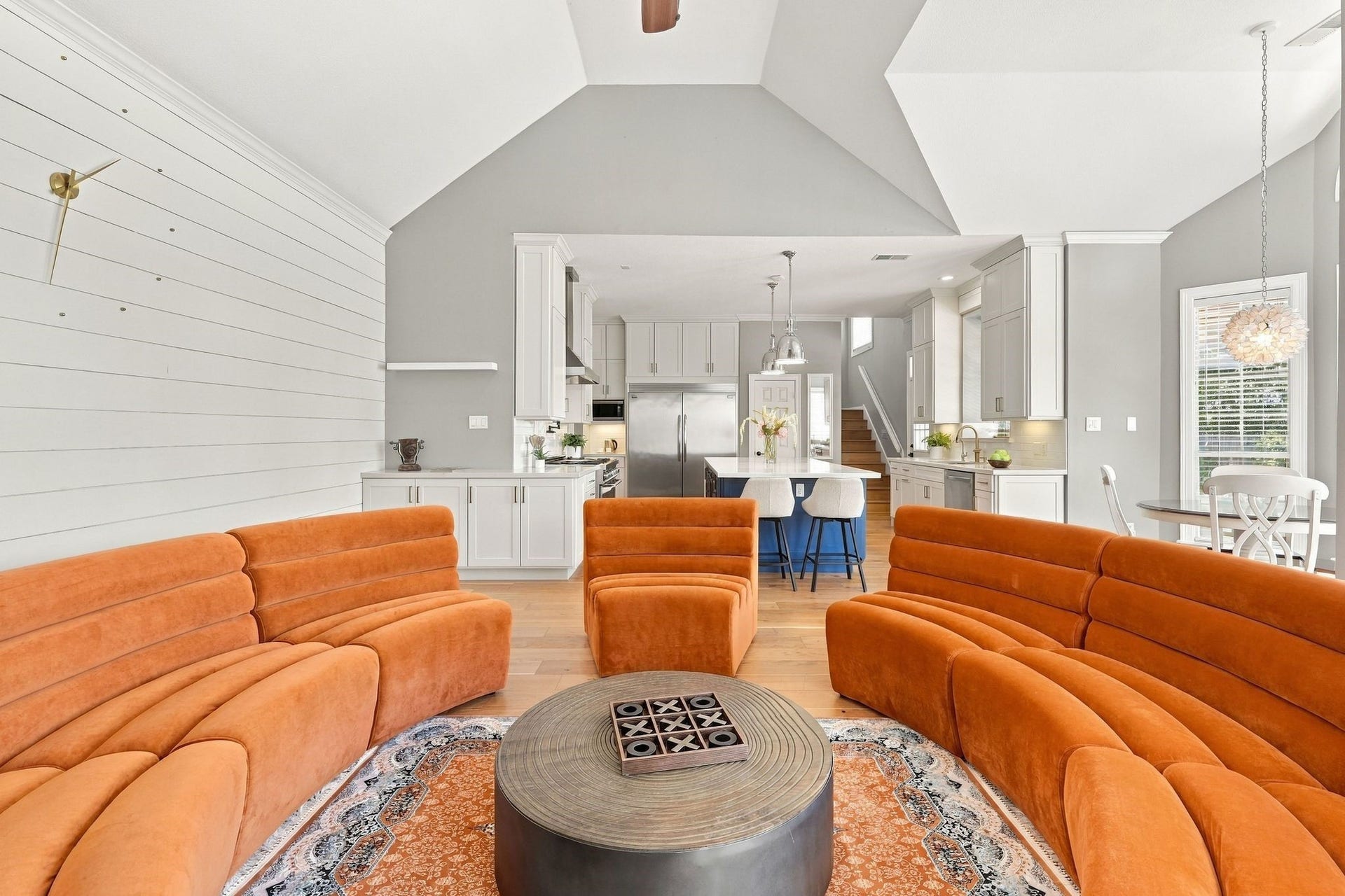 22 Hillside View Place, The Woodlands, TX 77381 The inviting family room features soaring ceilings, a dramatic floor to ceiling stone fireplace and walls of windows overlooking the backyard.