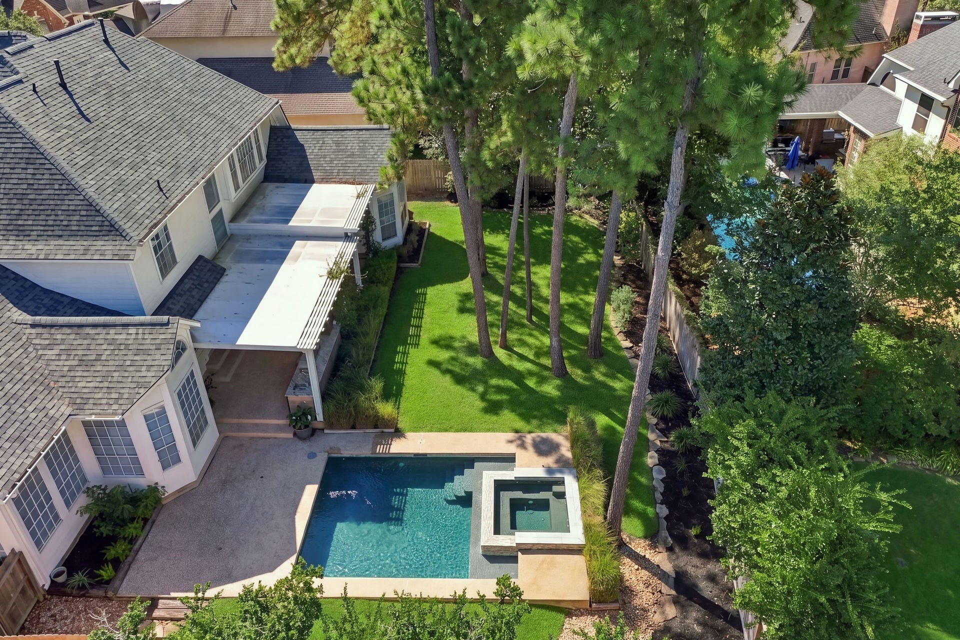 22 Hillside View Place, The Woodlands, TX 77381 The resort style pool and spa are surrounded by the beautiful tall trees that The Woodlands is known for. It is rare to find a home with such a sizable yard as this.