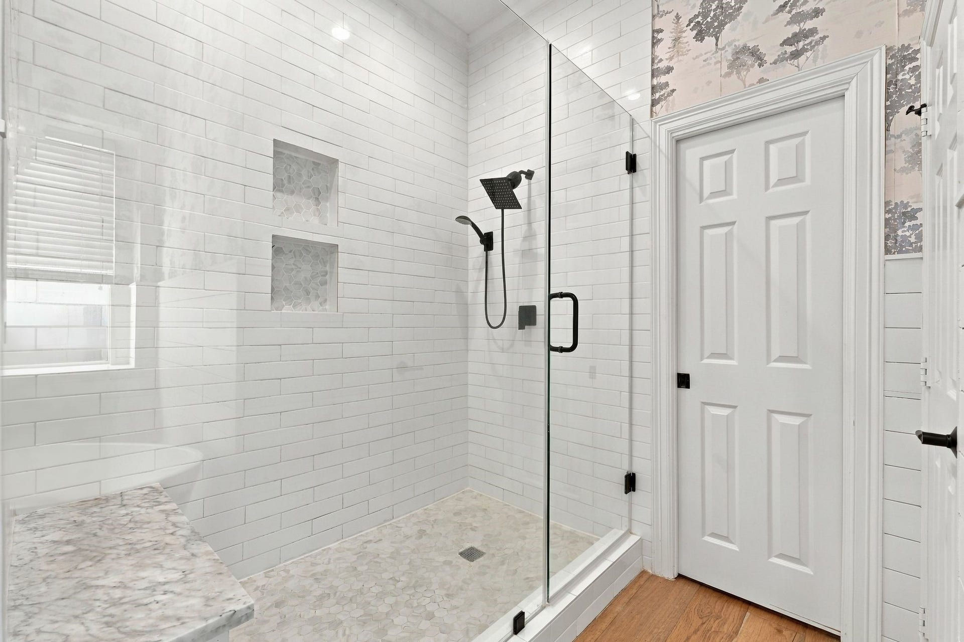 22 Hillside View Place, The Woodlands, TX 77381 Generously sized walk-in shower features frameless glass, timeless telework, built in niches and a convenient bench. Behind the sliding door is one of two large walk in closets.