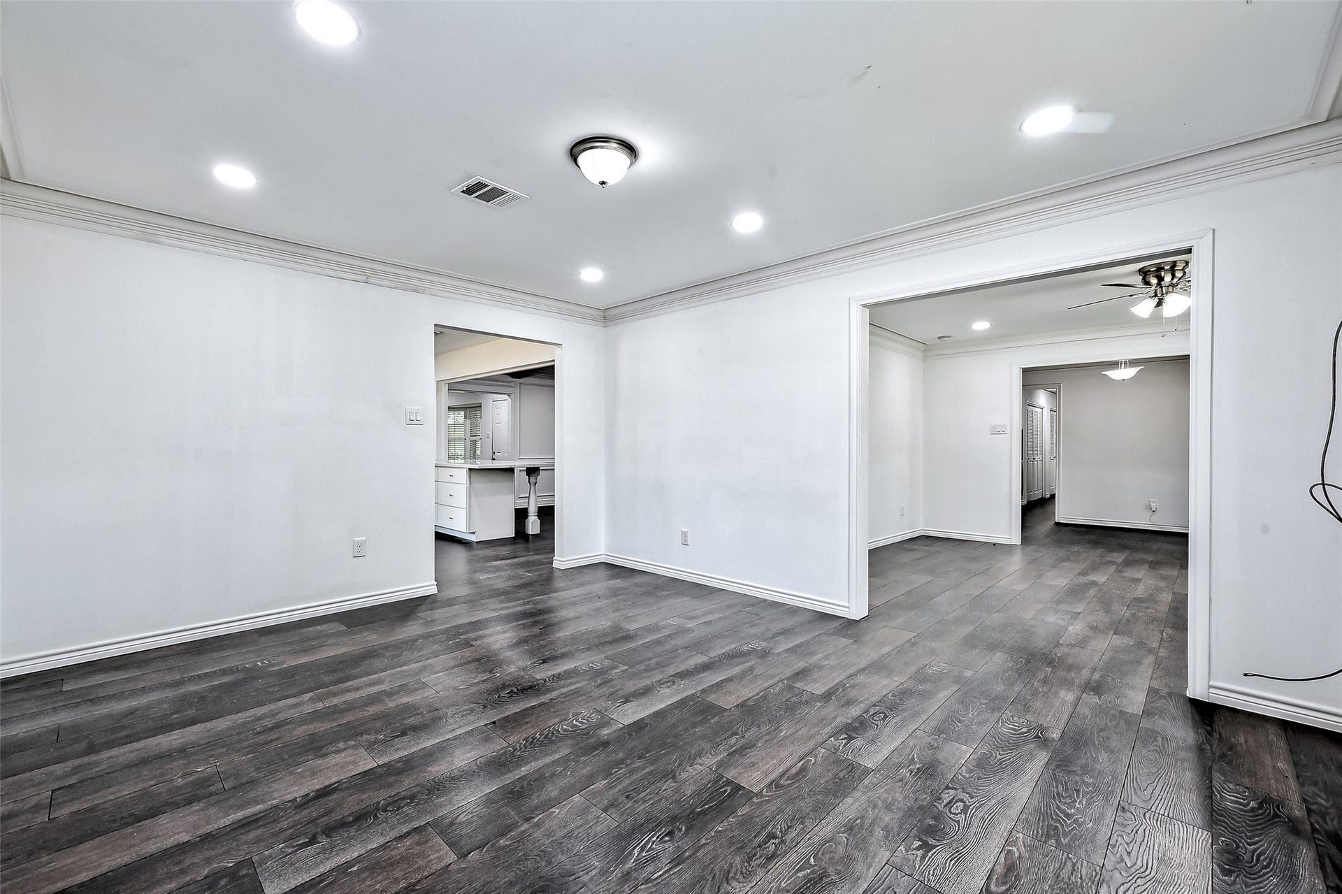 Dining room off the kitchen and next to living room is with many recess lights to make it so bright.