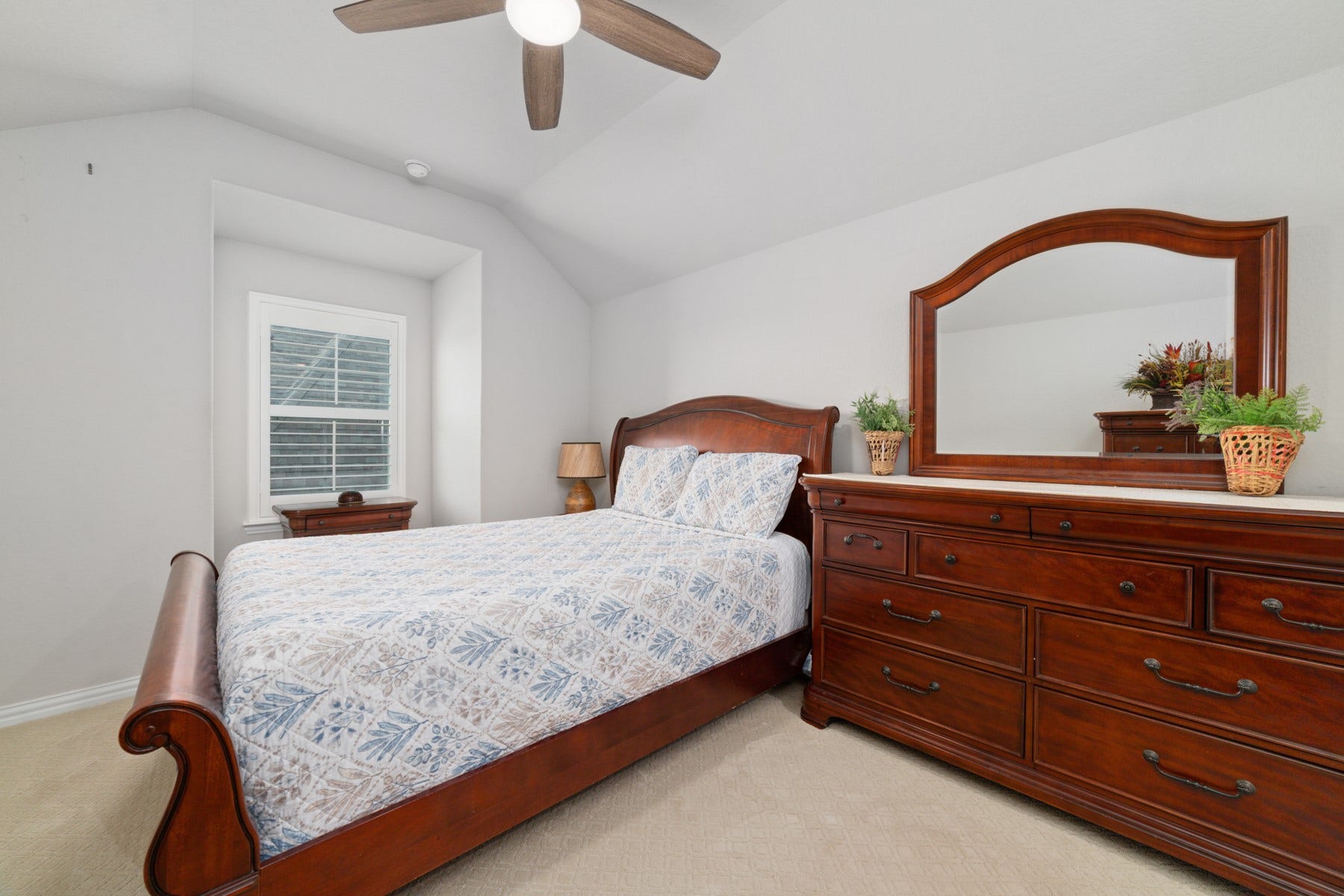Cozy bedroom with modern ceiling fan.