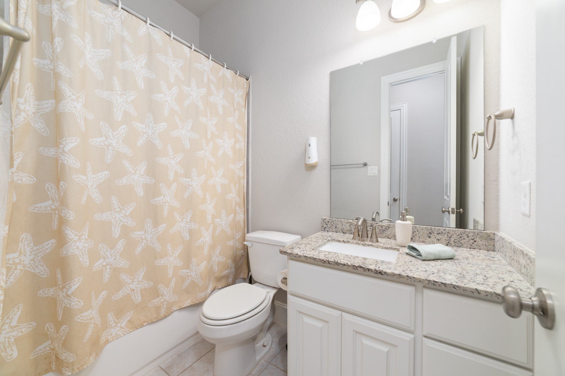 Charming bathroom with granite countertop.