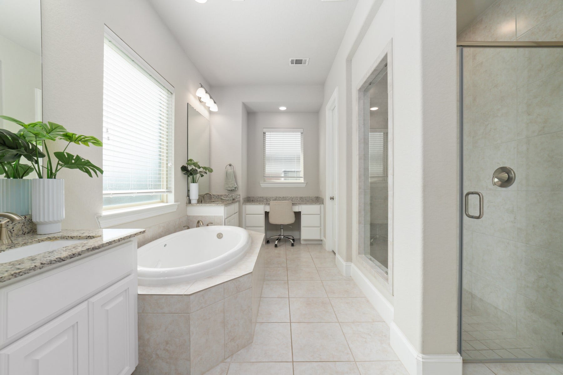 Luxurious bathroom featuring a spacious soaking tub, all bathed in natural light.