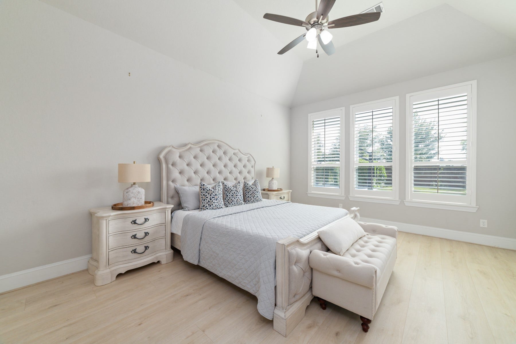 Spacious and serene bedroom featuring large windows that flood the space with natural light.